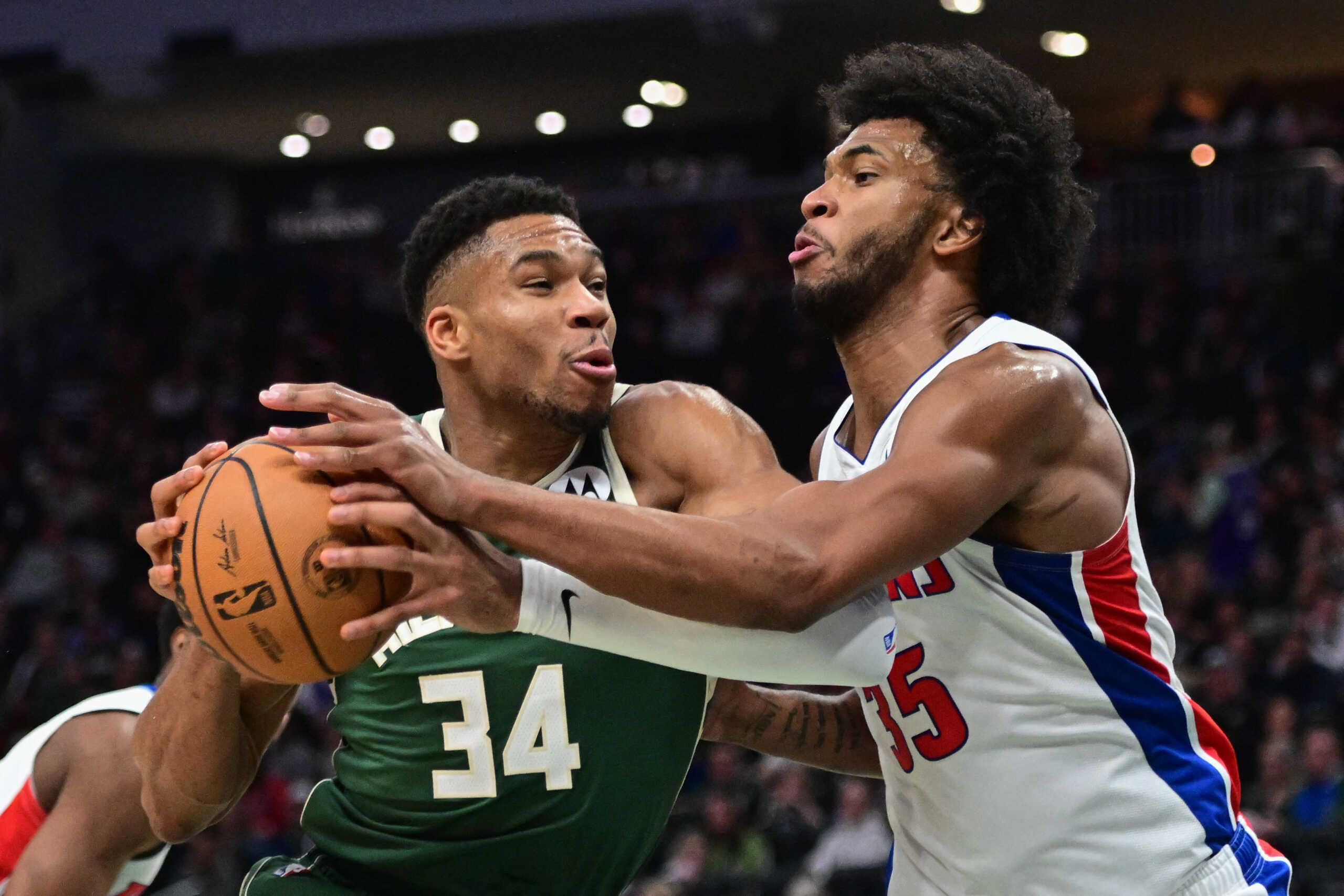 Dec 16, 2023; Milwaukee, Wisconsin, USA; Milwaukee Bucks forward Giannis Antetokounmpo (34) drives for he basket against Detroit Pistons center Marvin Bagley III (35) in the third quarter at Fiserv Forum. Mandatory Credit: Benny Sieu-USA TODAY Sports