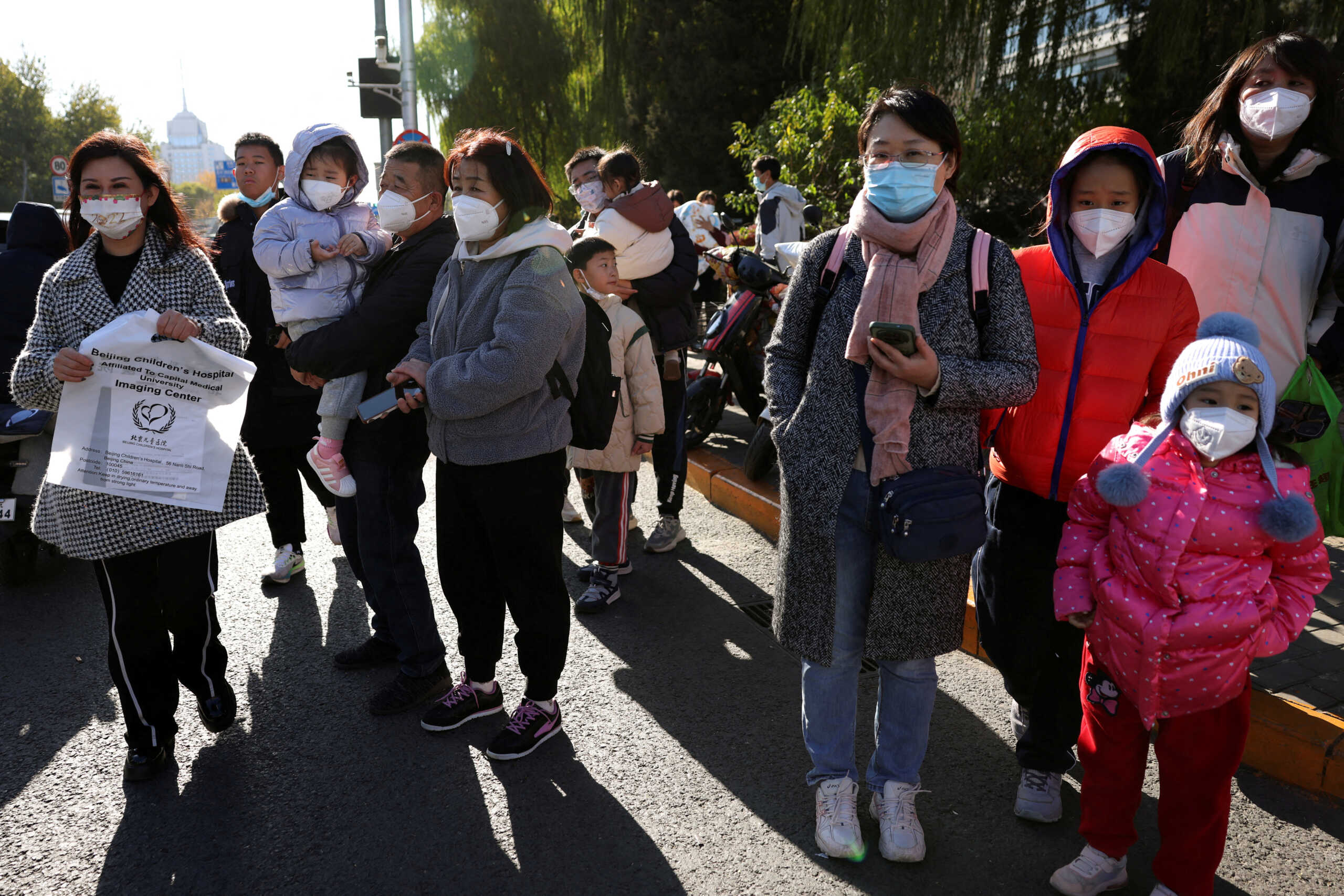 FILE PHOTO: People wait for their rides outside a children's hospital in Beijing, China November 24, 2023. REUTERS