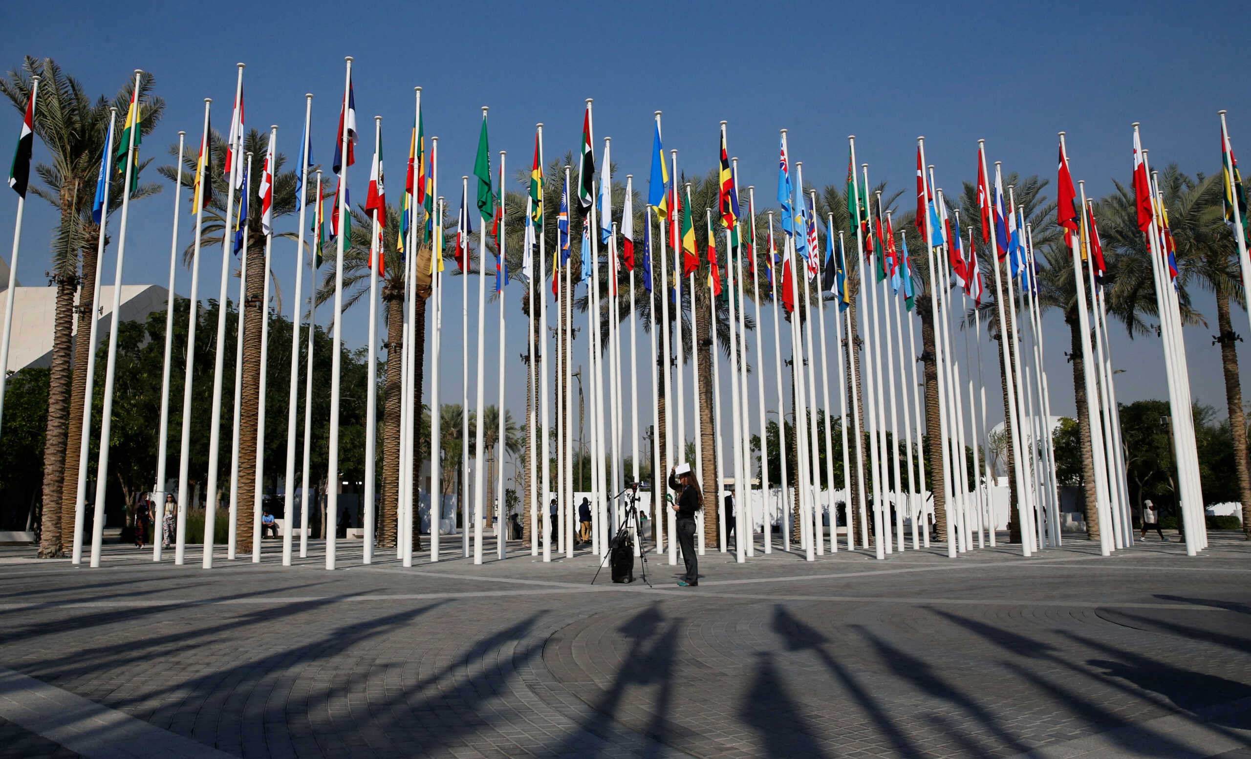 A journalist uses her mobile phone to record a video at Dubai's Expo City during the United Nations Climate Change Conference (COP28) in Dubai, United Arab Emirates, December 12, 2023. REUTERS