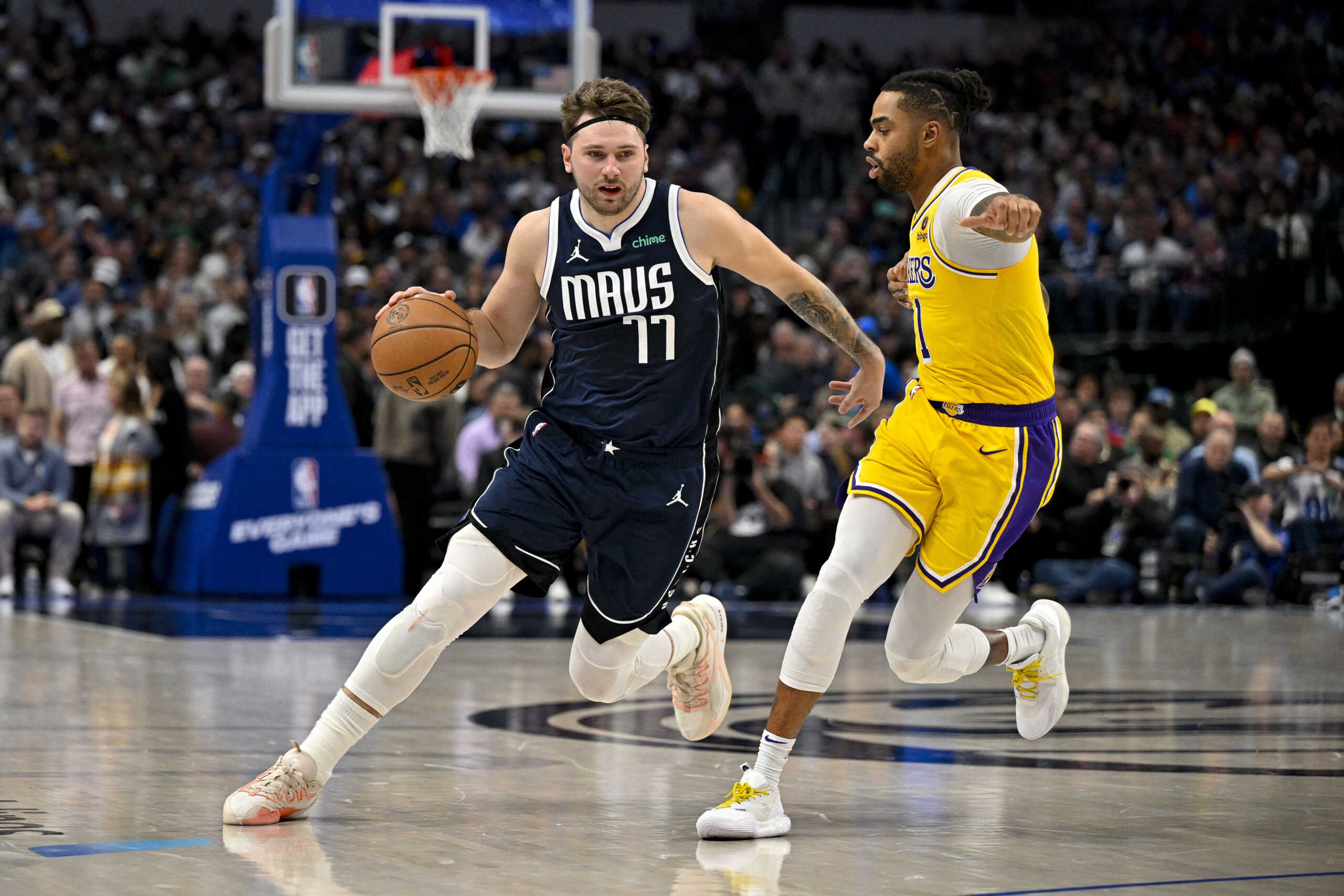 Dec 12, 2023; Dallas, Texas, USA; Dallas Mavericks guard Luka Doncic (77) drives to the basket past Los Angeles Lakers guard D'Angelo Russell (1) during the second half at the American Airlines Center. Mandatory Credit: Jerome Miron-USA TODAY Sports