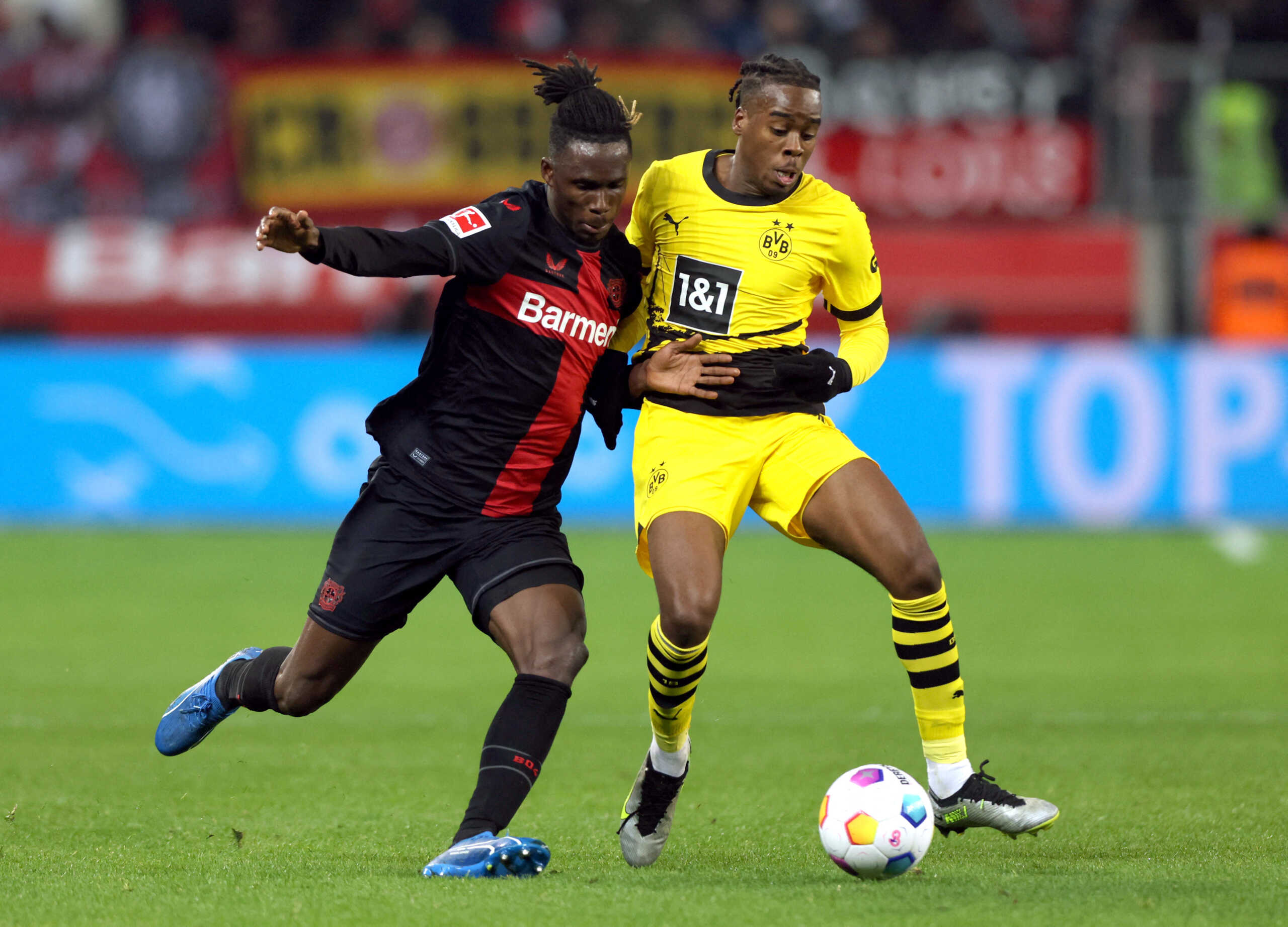 Soccer Football - Bundesliga - Bayer Leverkusen v Borussia Dortmund - BayArena, Leverkusen, Germany - December 3, 2023 Bayer Leverkusen's Odilon Kossounou in action with Borussia Dortmund's Jamie Bynoe-Gittens REUTERS