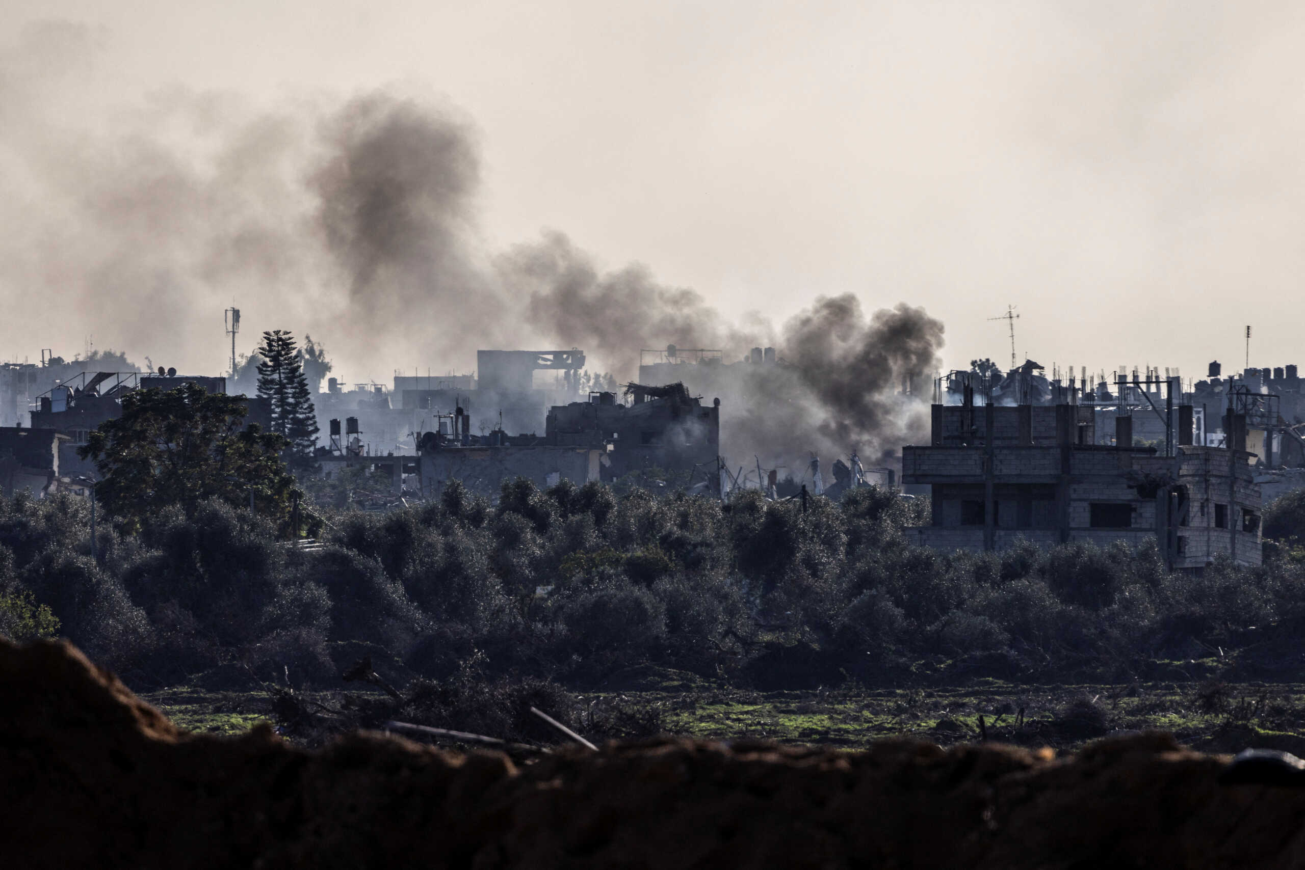 Smoke rises from damaged buildings, amid the ongoing ground operation of the Israeli army against Palestinian Islamist group Hamas, in the Gaza Strip, December 15, 2023. REUTERS