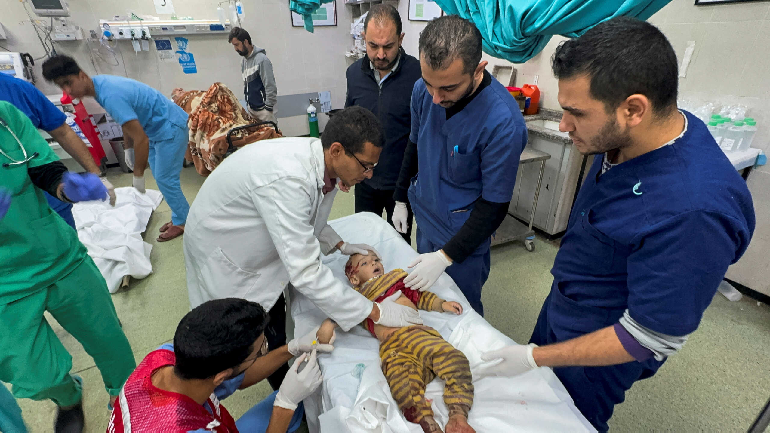 Medical professionals treat a Palestinian child wounded in Israeli strikes at Nasser hospital, amid the ongoing conflict between Israel and Palestinian Islamist group Hamas, in Khan Younis, in the southern Gaza Strip December 15, 2023. REUTERS