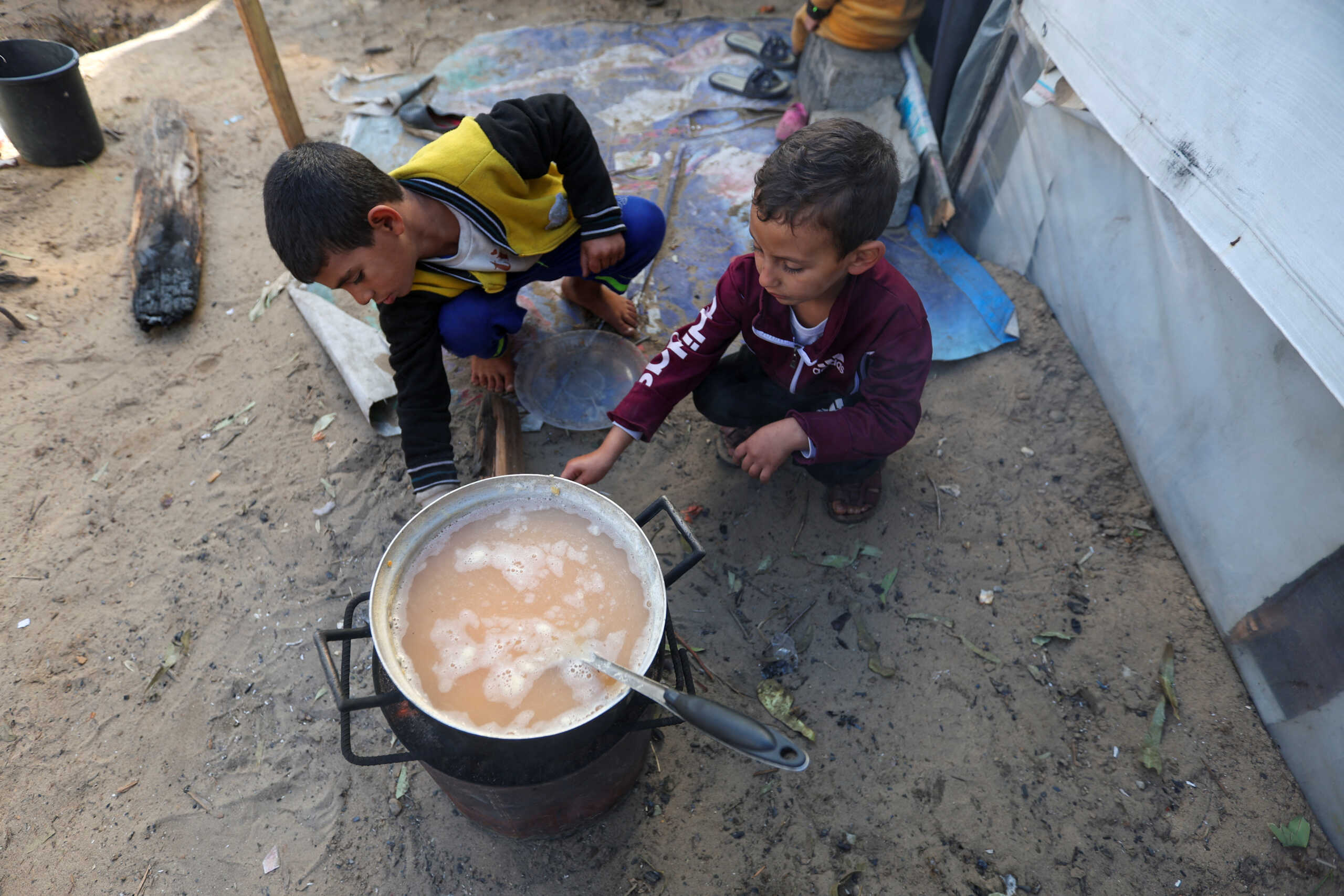 Displaced Palestinian children, who fled their house due to Israeli strikes, shelter in a tent camp, amid the ongoing conflict between Israel and the Palestinian Islamist group Hamas, in Khan Younis in the southern Gaza Strip, December 11, 2023. REUTERS