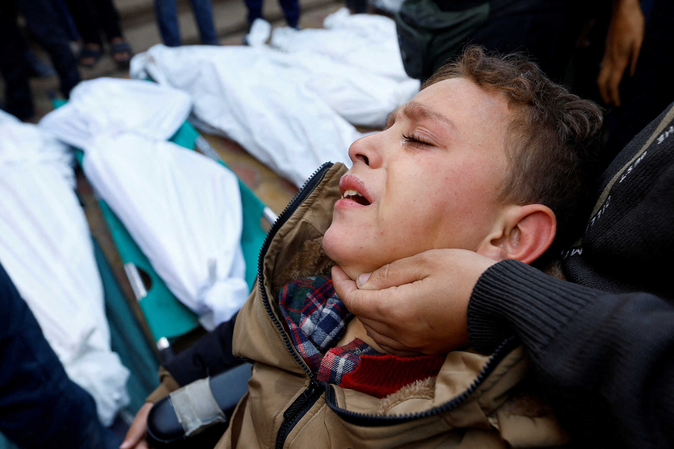 A Palestinian boy, who was injured in an Israeli raid reacts, as he attends the funeral of family members who were killed in the raid, amid the ongoing conflict between Israel and the Palestinian Islamist group Hamas, at Nasser hospital in Khan Younis, in the southern Gaza Strip, December 10, 2023. REUTERS