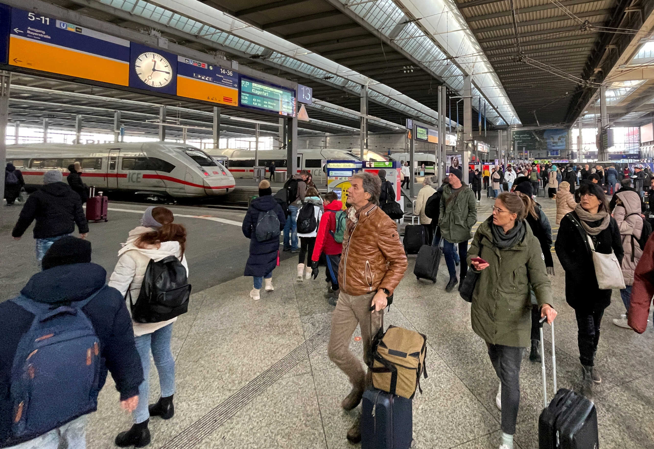 People walk at the main train station Hauptbahnhof, one day after heavy snowfall hit Bavaria and its capital Munich, Germany, December 3, 2023. Yesterday the German Bundesliga soccer match FC Bayern Munich v 1. FC Union Berlin had to be cancelled, trains halted and the airport closed because of the weather condition.       REUTERS