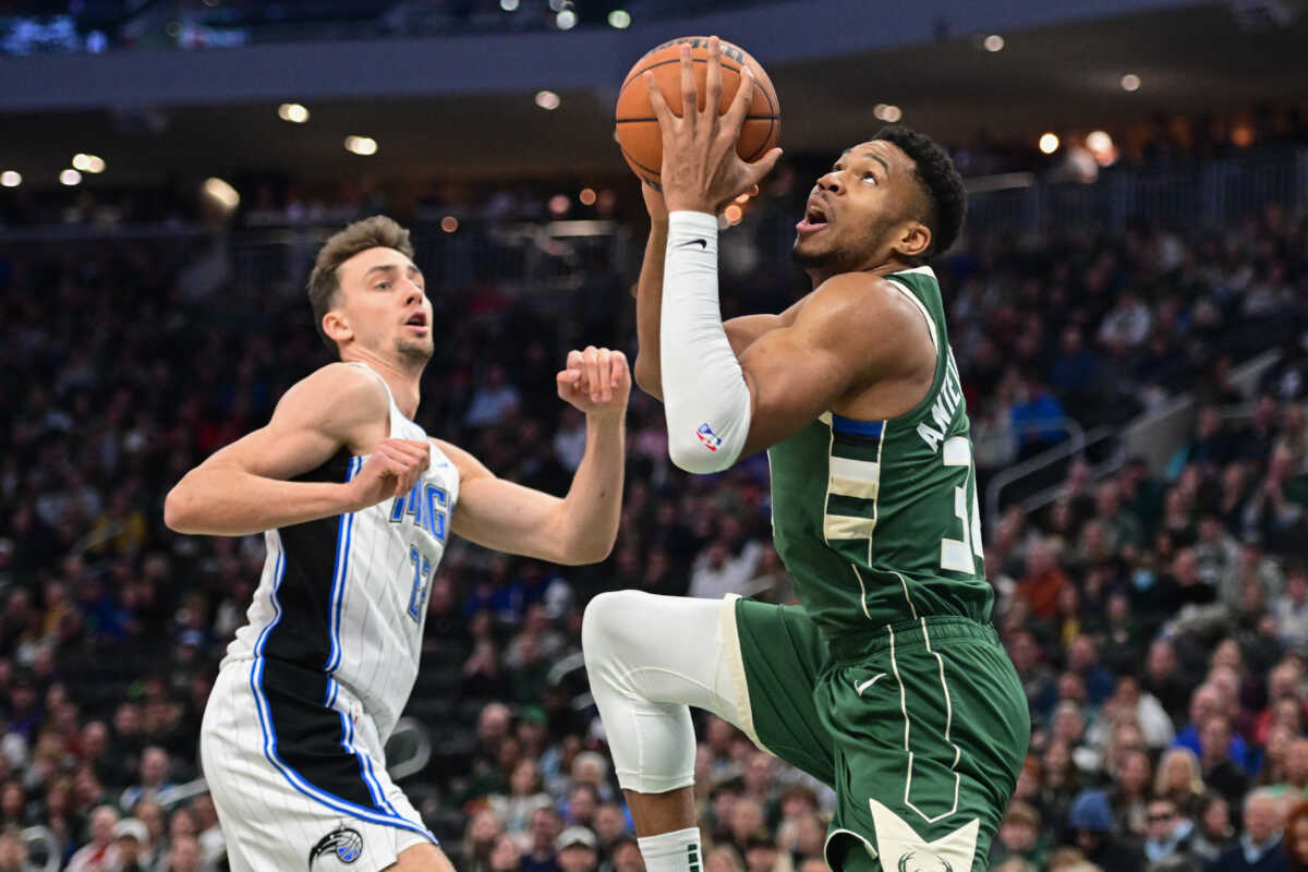 Dec 21, 2023; Milwaukee, Wisconsin, USA; Milwaukee Bucks forward Giannis Antetokounmpo (34) takes a shot against Orlando Magic forward Franz Wagner (22) in the first quarter at Fiserv Forum. Mandatory Credit: Benny Sieu-USA TODAY Sports