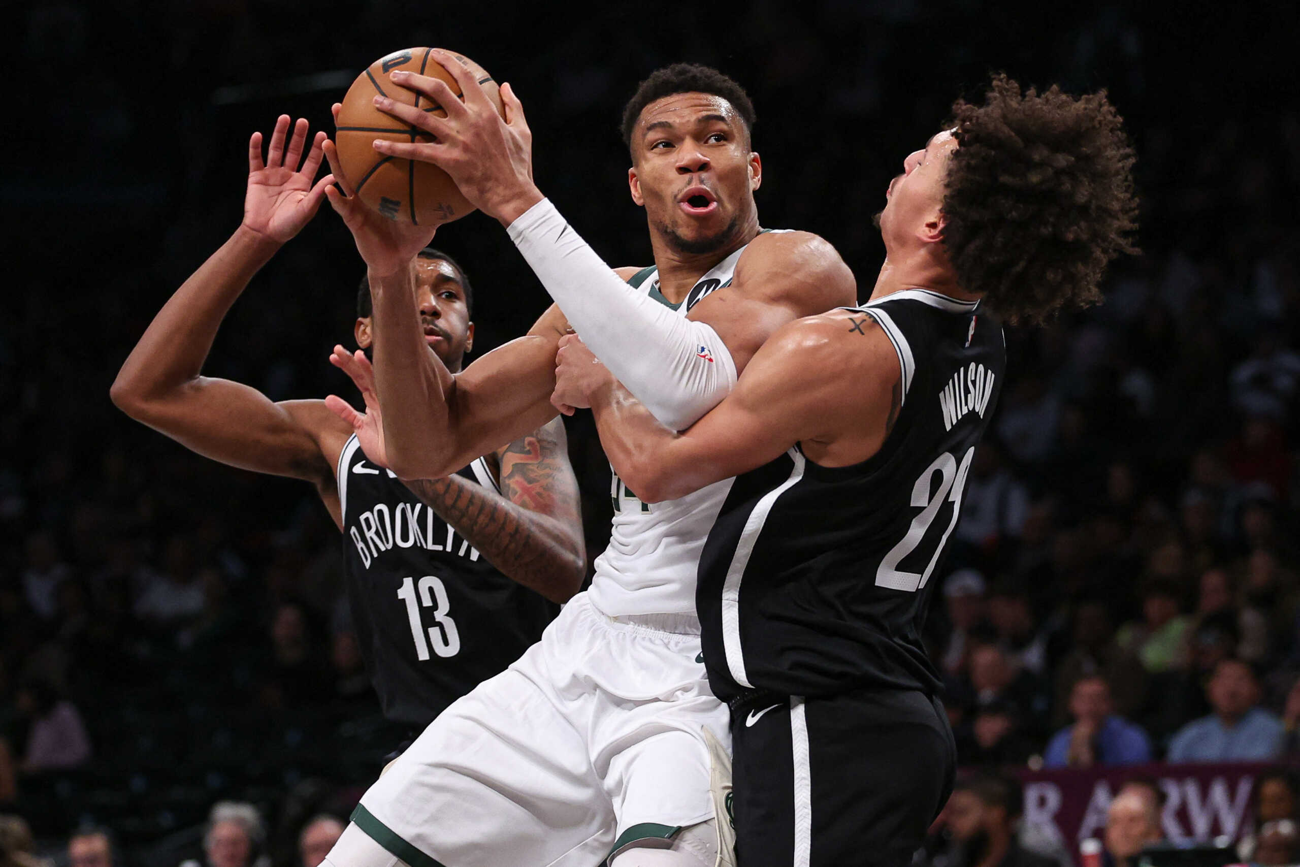 Dec 27, 2023; Brooklyn, New York, USA; Milwaukee Bucks forward Giannis Antetokounmpo (34) is fouled by Brooklyn Nets forward Jalen Wilson (22) in front of guard Armoni Brooks (13) during the second half at Barclays Center. Mandatory Credit: Vincent Carchietta-USA TODAY Sports