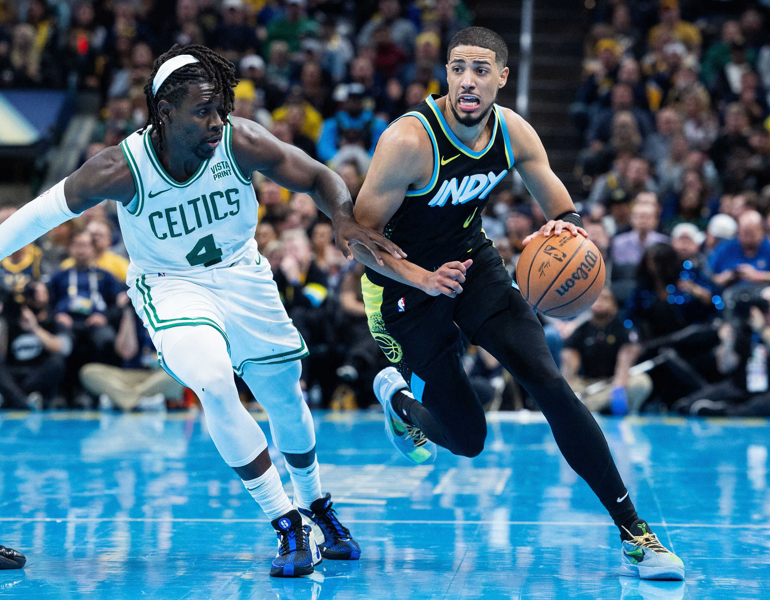 Dec 4, 2023; Indianapolis, Indiana, USA; Indiana Pacers guard Tyrese Haliburton (0) dribbles the ball while Boston Celtics guard Jrue Holiday (4) defends in the second half at Gainbridge Fieldhouse. Mandatory Credit: Trevor Ruszkowski-USA TODAY Sports