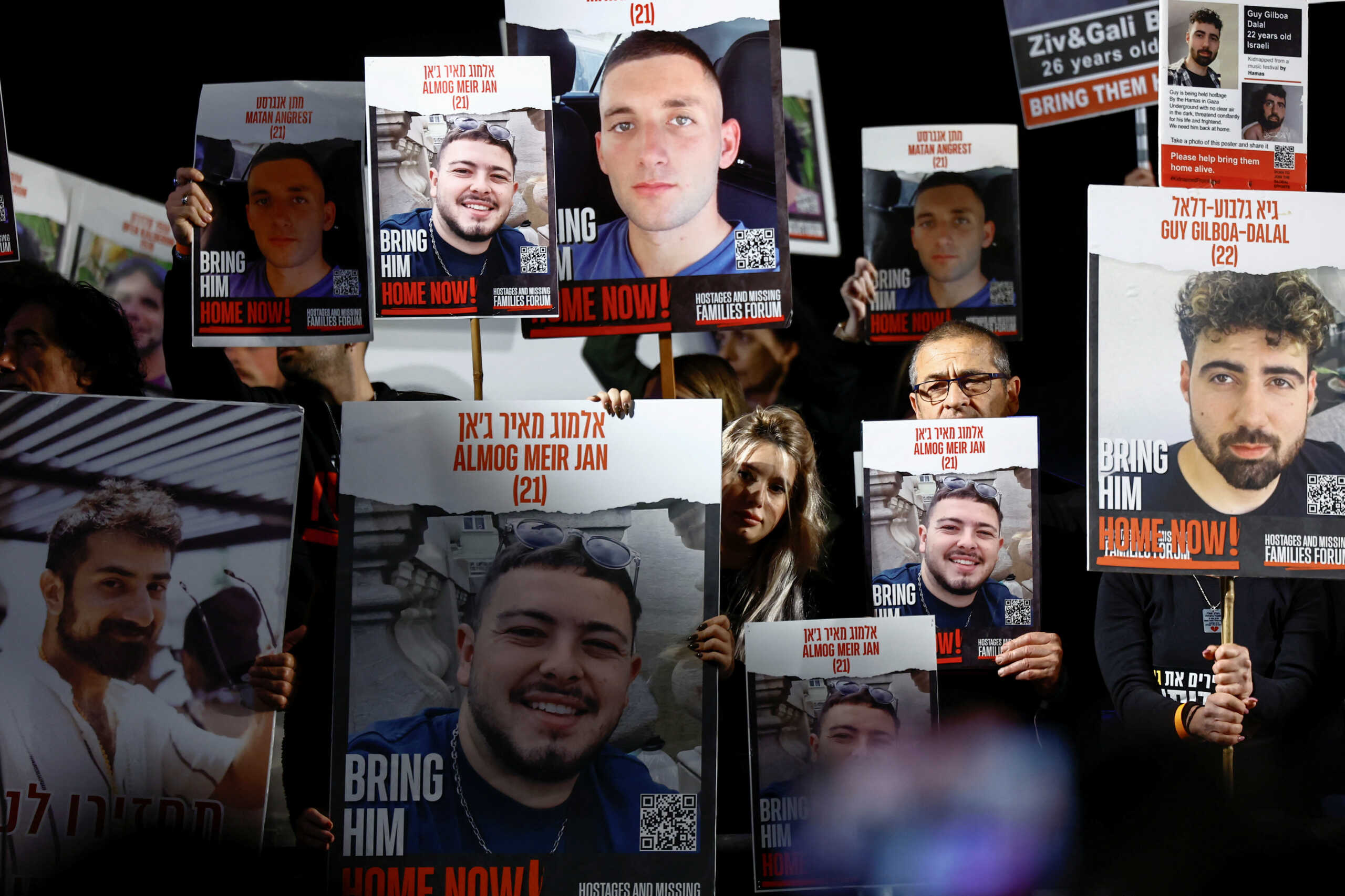 People hold placards during a rally calling for the release of hostages kidnapped on the deadly October 7 attack by Palestinian Islamist group Hamas, amid the ongoing conflict between Israel and the Palestinian Islamist group Hamas, in Tel Aviv, Israel, December 9, 2023. REUTERS