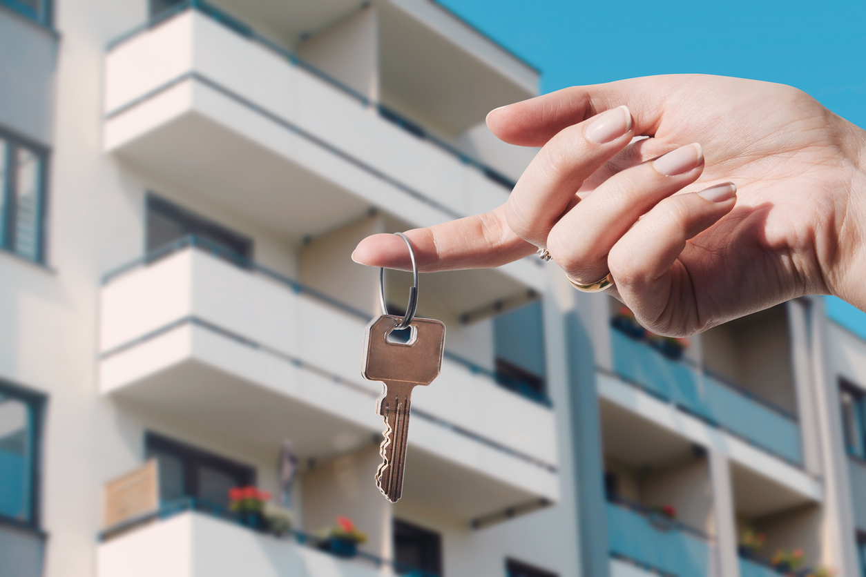Real estate agent holding keys to new flat. Real estate, buy a home concept