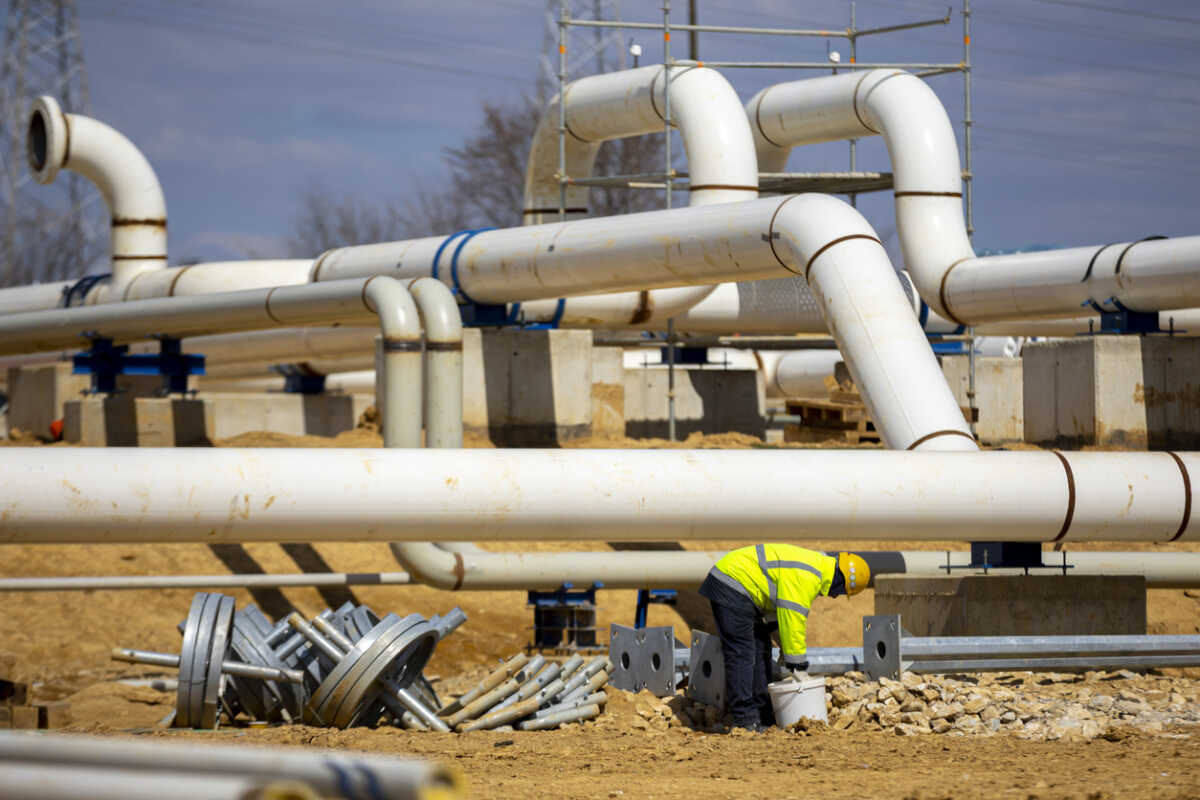 Worker works on a construction site of an interconnected natural gas transmission pipeline. Highly integrated network that moves natural gas. Connection point between the transmission company and the receiving party.
