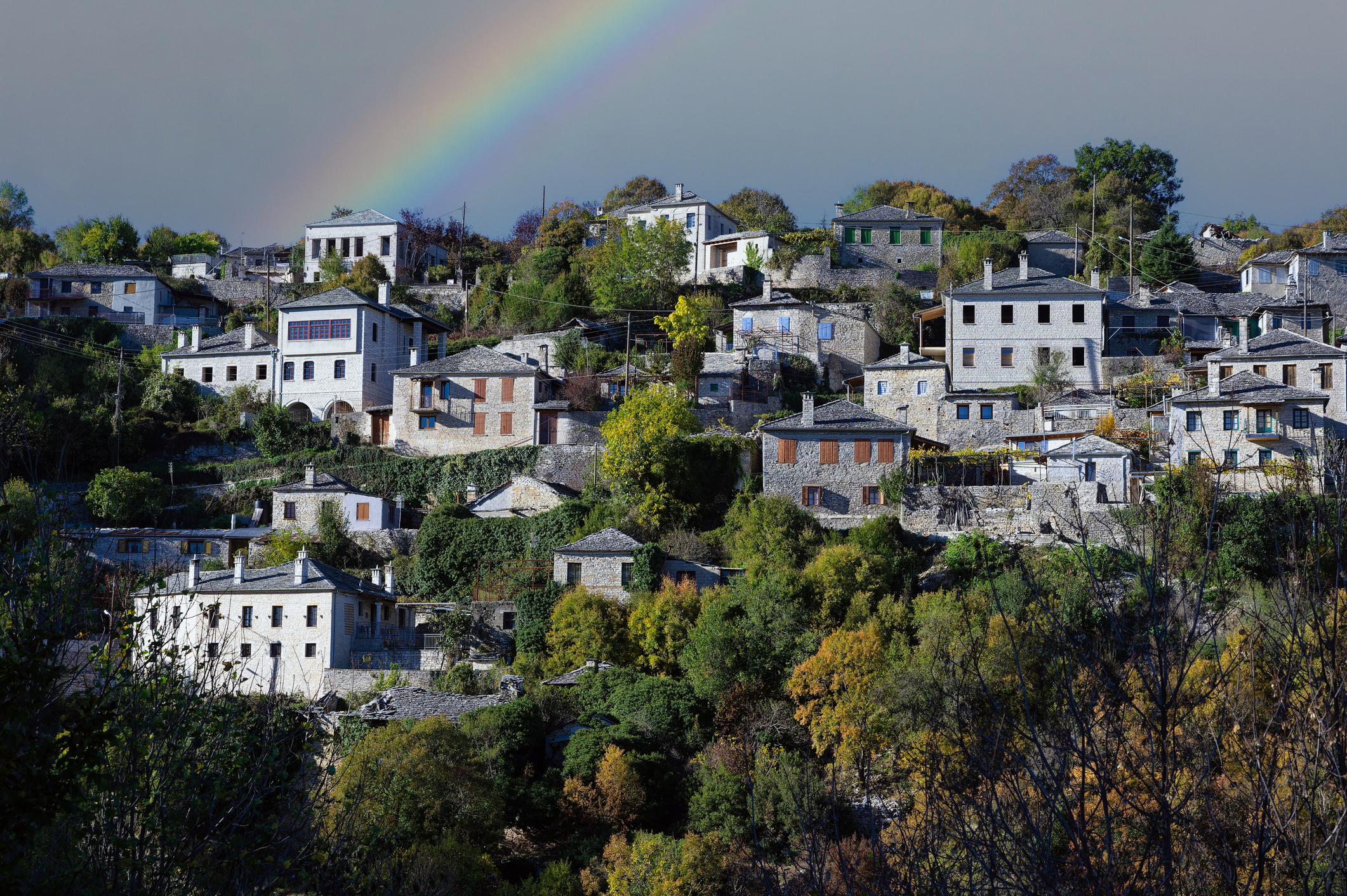 Autumnal landscape showing the stone houses of traditional architecture in the village of Kipi in Epirus, Greece after heavy rain