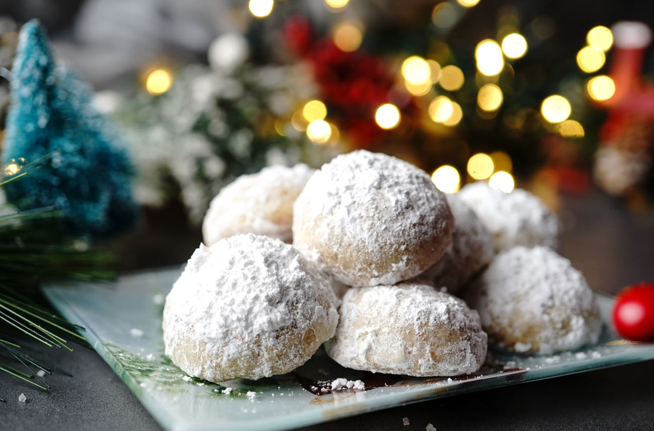Homemade Snowball or Mexican wedding cookies on holiday background, selective focus