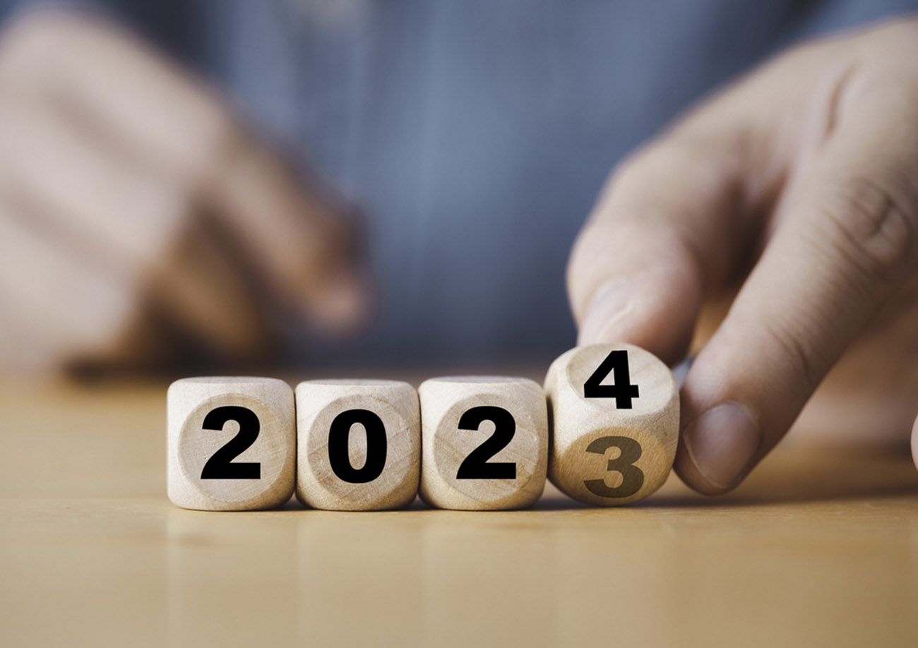 Hand flipping of 2023 to 2024 on wooden block cube for preparation new year change and start new business target strategy concept.