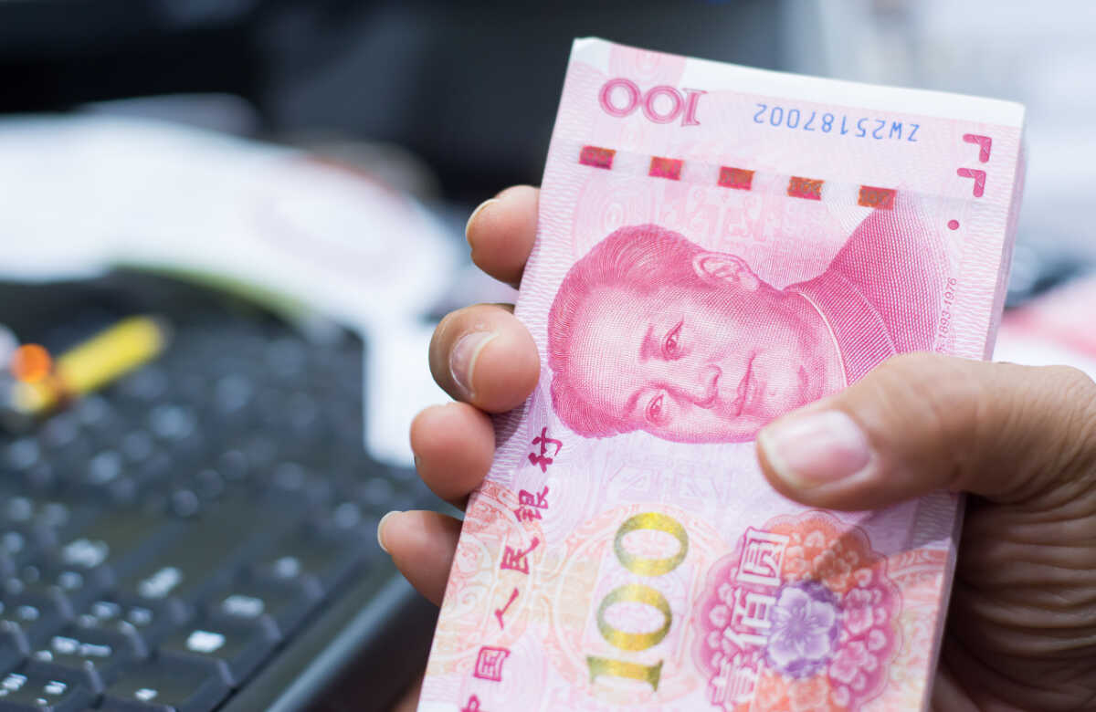 Chinese currency in a hand , Focus on eye of a man on banknote