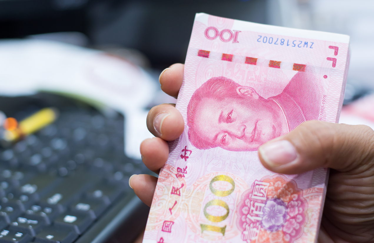 Chinese currency in a hand , Focus on eye of a man on banknote