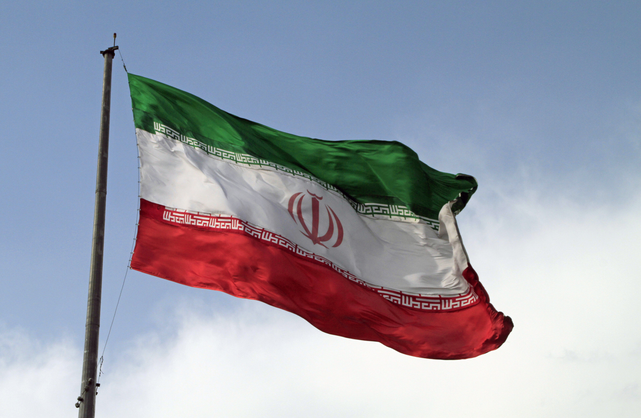 A big flag of Iran waving in the wind in Tehran, Iran.