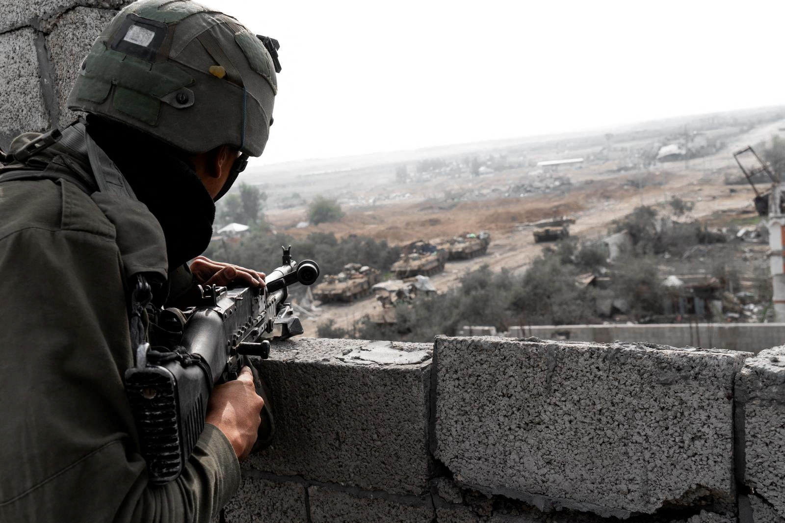 Israeli soldiers operate in the Gaza Strip amid the ongoing conflict between Israel and the Palestinian Islamist group Hamas, in this handout picture released on December 18, 2023.  Israel Defense Forces
