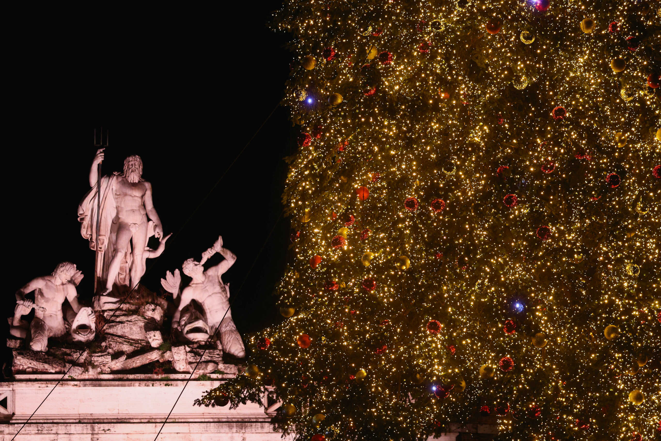 A Christmas tree is lit up in Piazza del Popolo in Rome, Italy, December 8, 2023. REUTERS