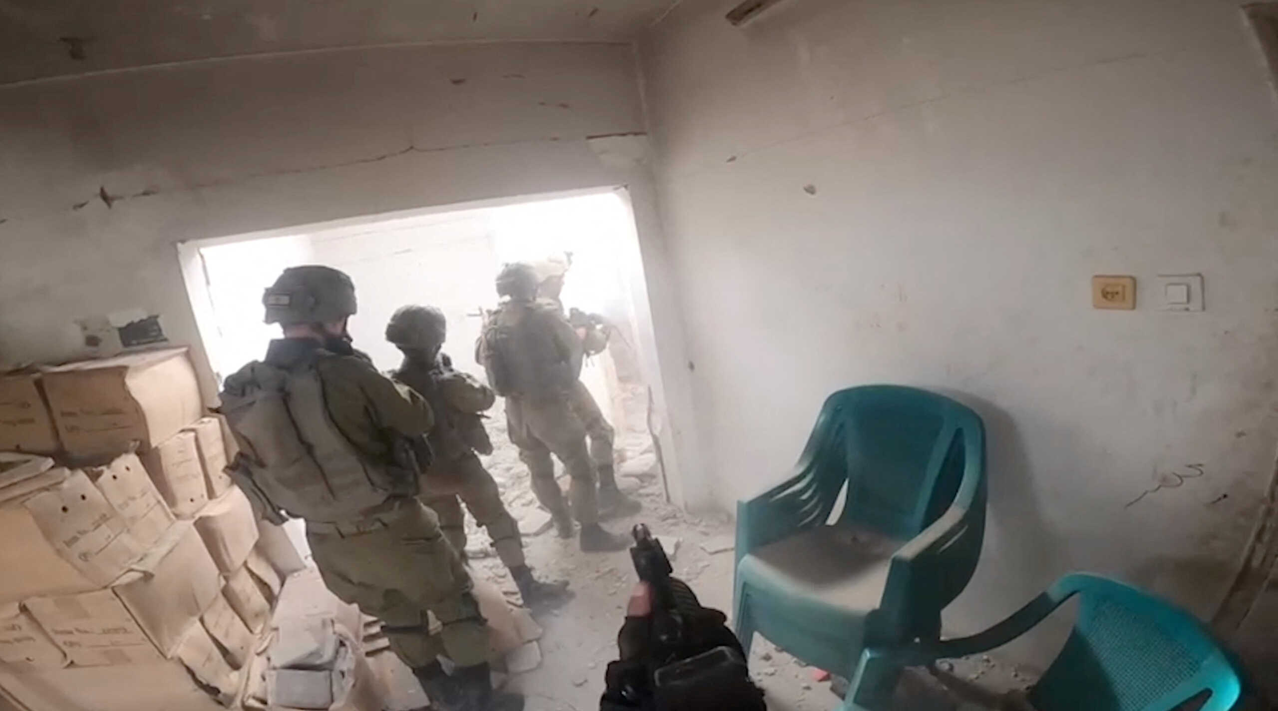Bodycam footage shows Israeli soldiers going into a damaged building during what the Israeli army says was an operation in Khan  Younis, in the southern Gaza Strip, in this screengrab taken from a video released on December 8, 2023. Israel Defense Forces