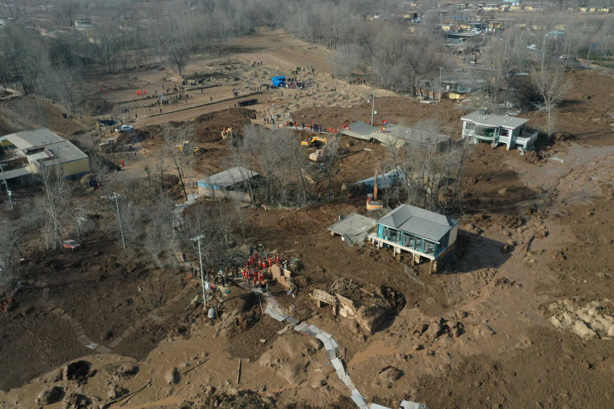 An aerial view shows buildings covered in silt amid rescue operations after the earthquake in Gansu's Jishishan county triggered a mudslide in Jintian village, Qinghai province, China December 19, 2023. cnsphoto via REUTERS   ATTENTION EDITORS - THIS IMAGE WAS PROVIDED BY A THIRD PARTY. CHINA OUT.