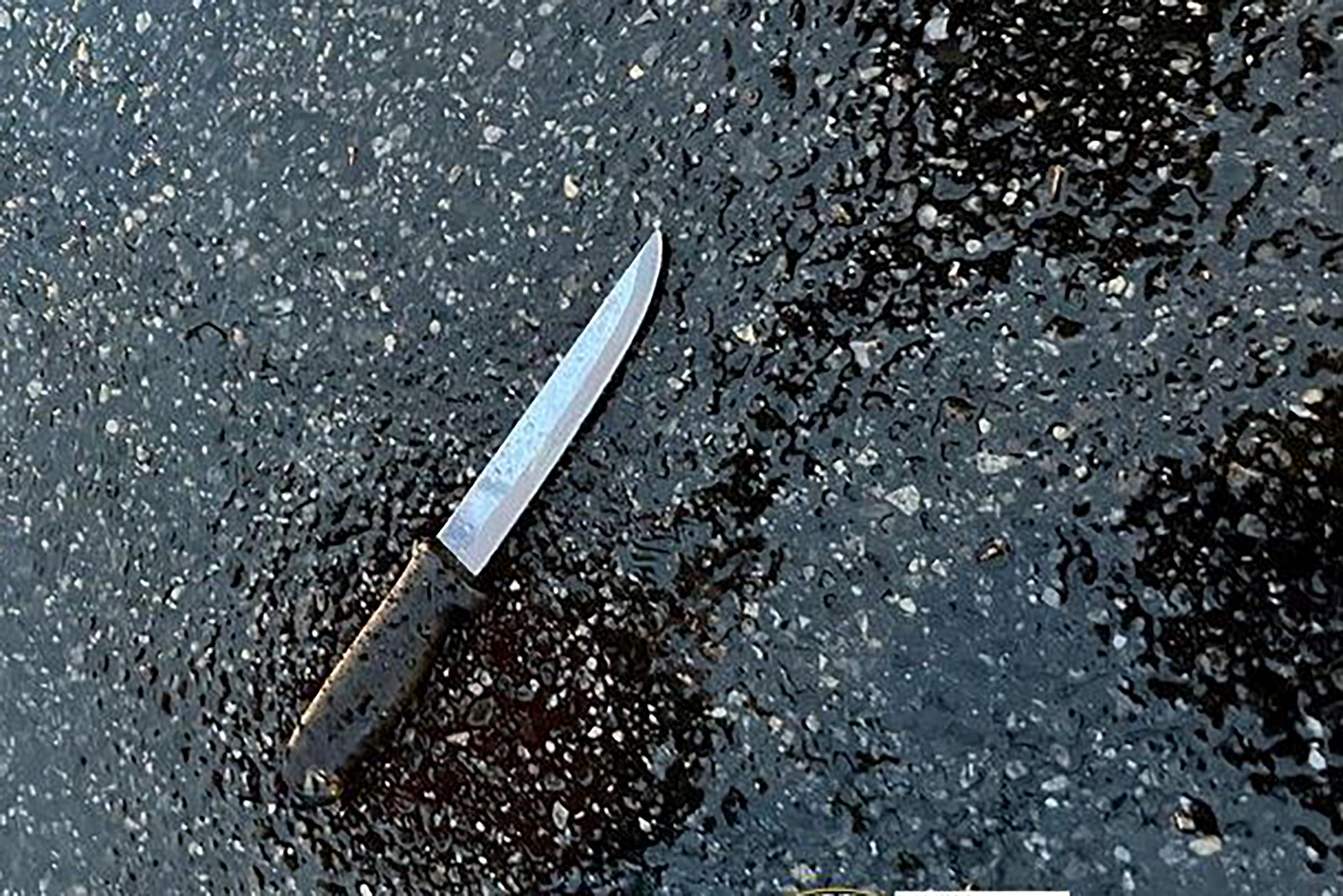 A knife found at the scene lies on pavement after a man, who was later shot dead by police, killed four members of his extended family, including two children, and stabbed two police officers at a home in the Queens borough of New York City, U.S. December 3, 2023.  NYPD