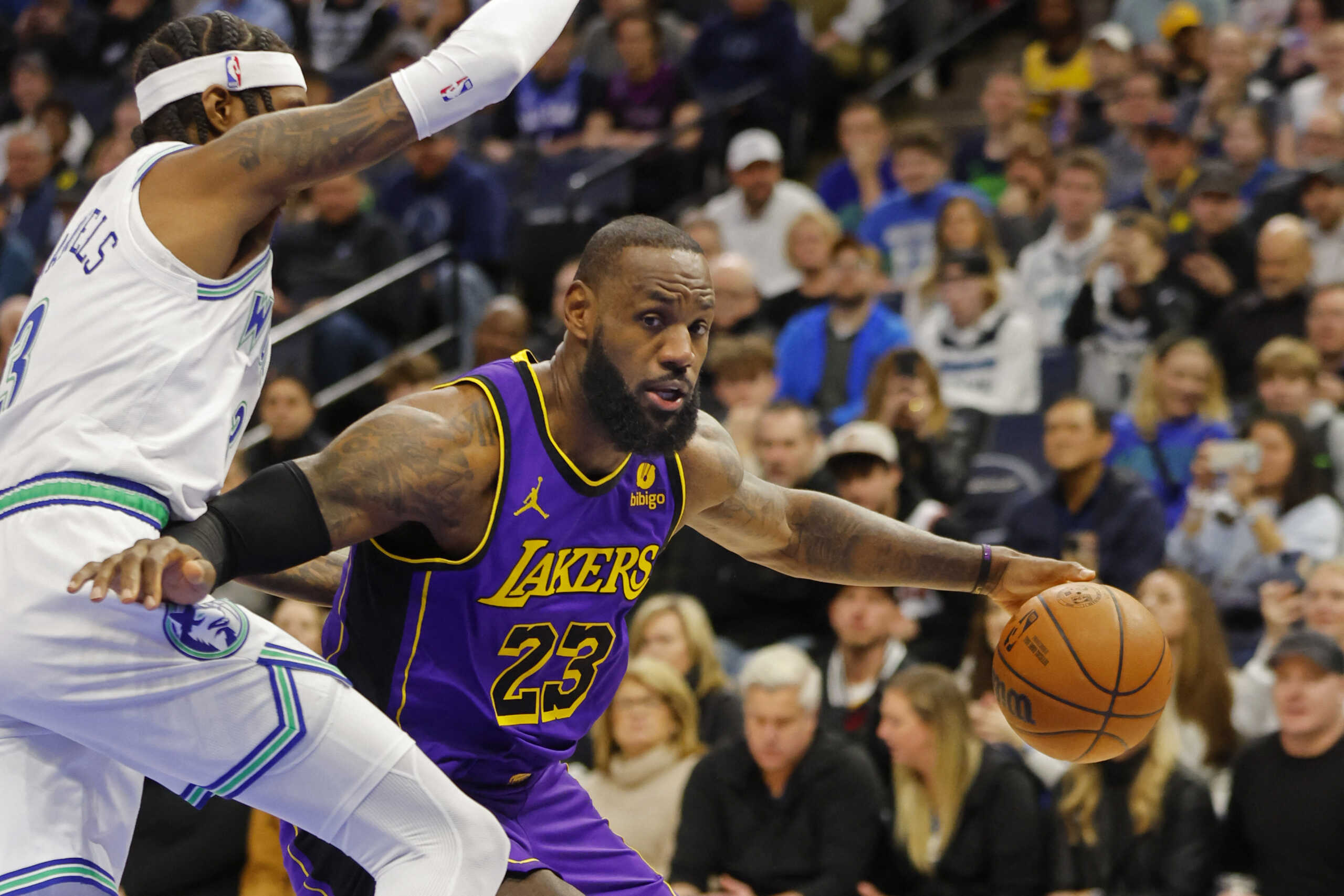 Dec 30, 2023; Minneapolis, Minnesota, USA; Los Angeles Lakers forward LeBron James (23) works around Minnesota Timberwolves forward Jaden McDaniels (3) in the first quarter at Target Center. Mandatory Credit: Bruce Kluckhohn-USA TODAY Sports