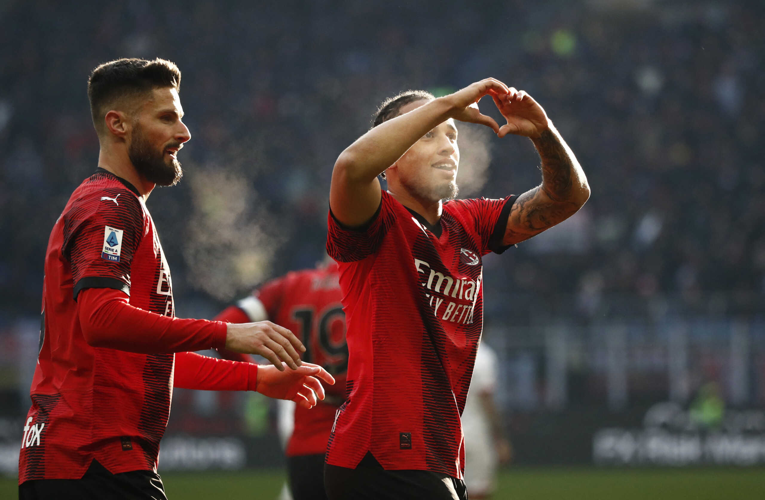 Soccer Football - Serie A - AC Milan v Monza - San Siro, Milan, Italy - December 17, 2023 AC Milan's Noah Okafor celebrates scoring their third goal with Olivier Giroud REUTERS