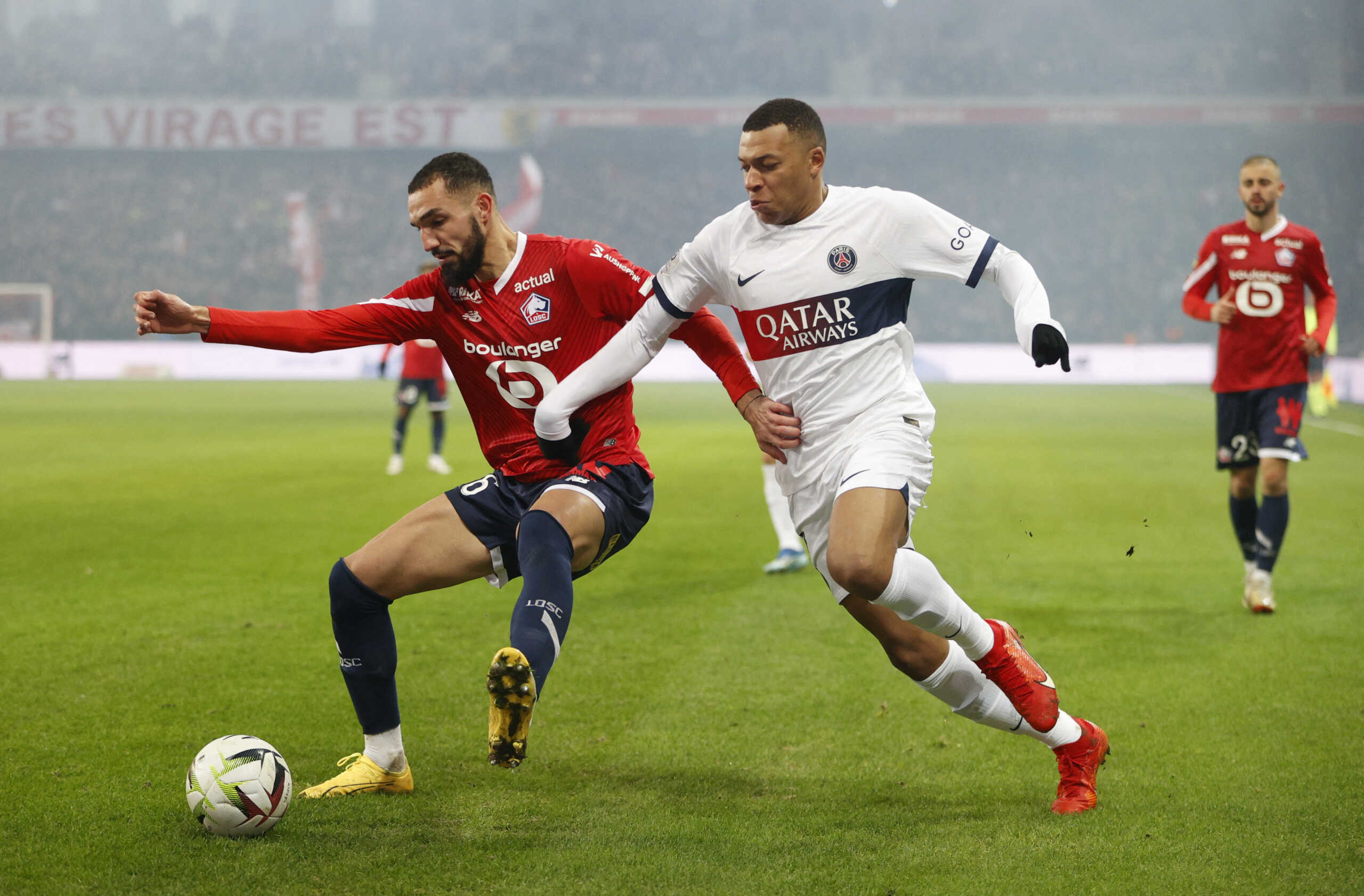 Soccer Football - Ligue 1 - Lille v Paris St Germain - Stade Pierre-Mauroy, Villeneuve-d'Ascq, France - December 17, 2023 Paris St Germain's Kylian Mbappe in action with Lille's Nabil Bentaleb REUTERS