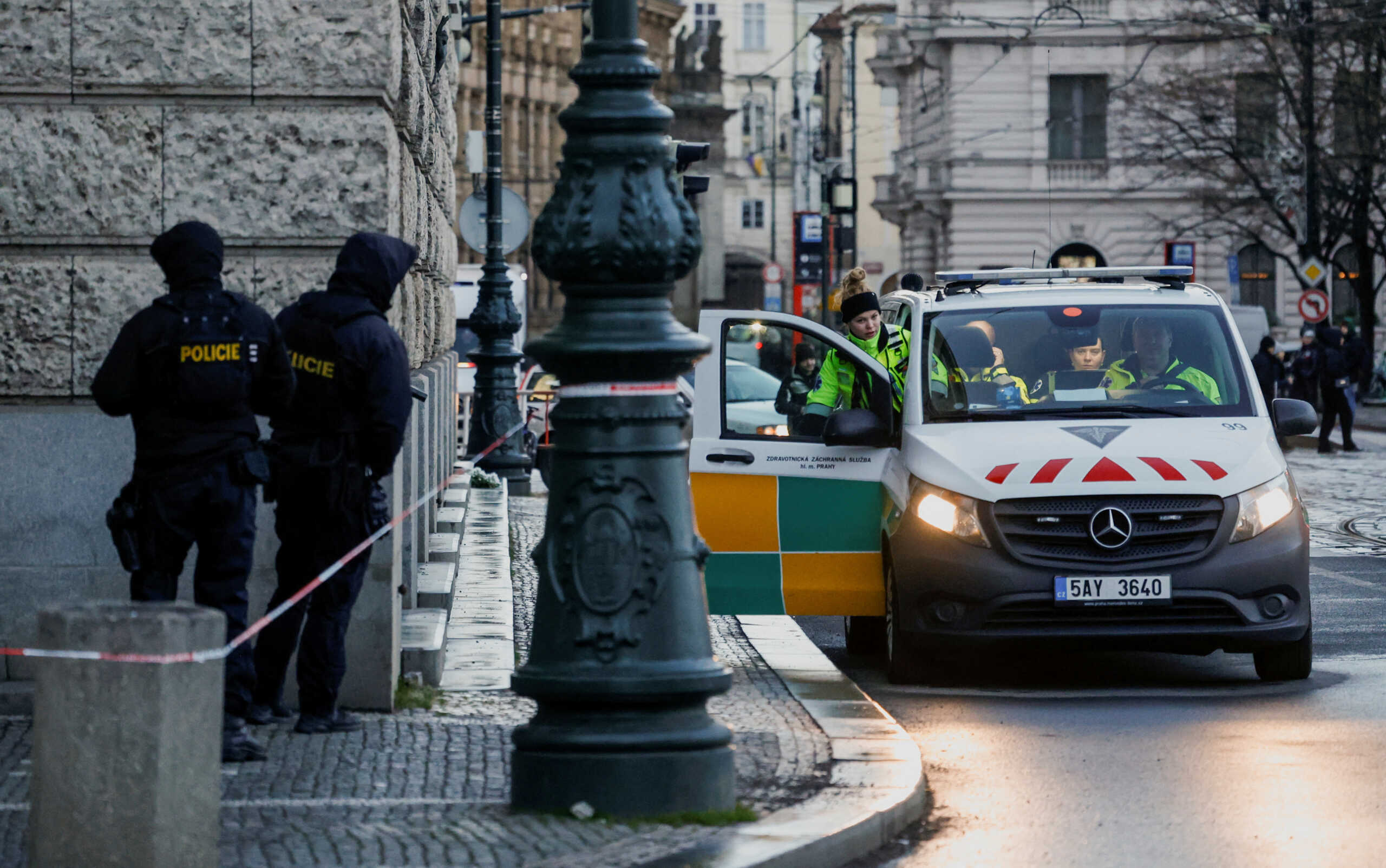 Members of the Police stand guard as a policewoman gets into a police car following a shooting at one of Charles University's buildings in Prague, Czech Republic, December 22, 2023. REUTERS