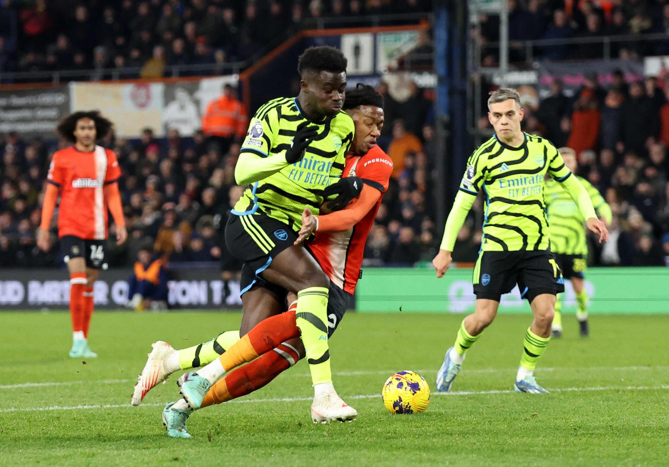 Soccer Football - Premier League - Luton Town v Arsenal - Kenilworth Road, Luton, Britain - December 5, 2023 Arsenal's Bukayo Saka in action with Luton Town's Gabriel Osho REUTERS