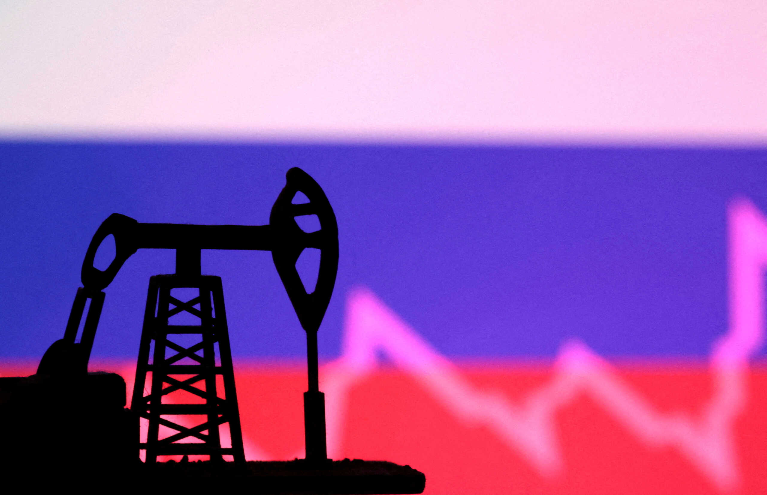 FILE PHOTO: Russian flag with stock graph and an oil pump jack miniature model are seen in this illustration taken October 9, 2023. REUTERS