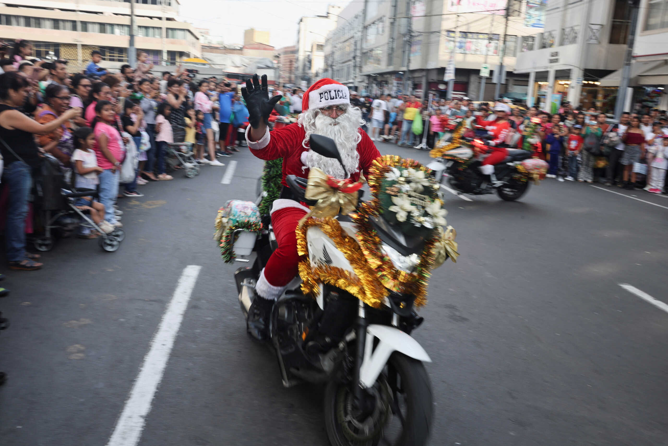 A police officer from the traffic squad dressed as Santa Claus rides on a motorcycle through the streets of Lima, ahead of Christmas, in Lima, Peru, on December 19, 2023. REUTERS