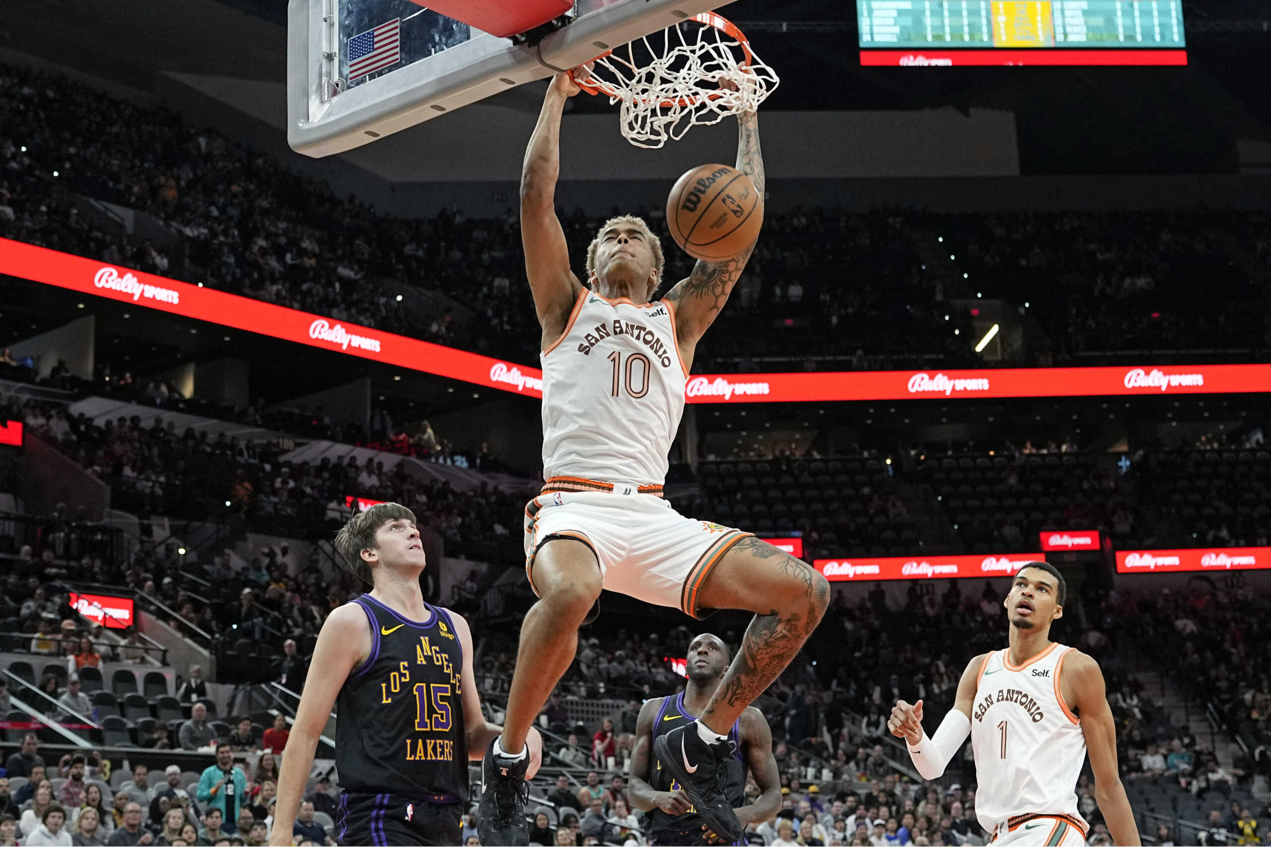 Dec 15, 2023; San Antonio, Texas, USA; San Antonio Spurs forward Jeremy Sochan (10) dunks over Los Angeles Lakers guard Austin Reaves (15) during the first half at Frost Bank Center. Mandatory Credit: Scott Wachter-USA TODAY Sports