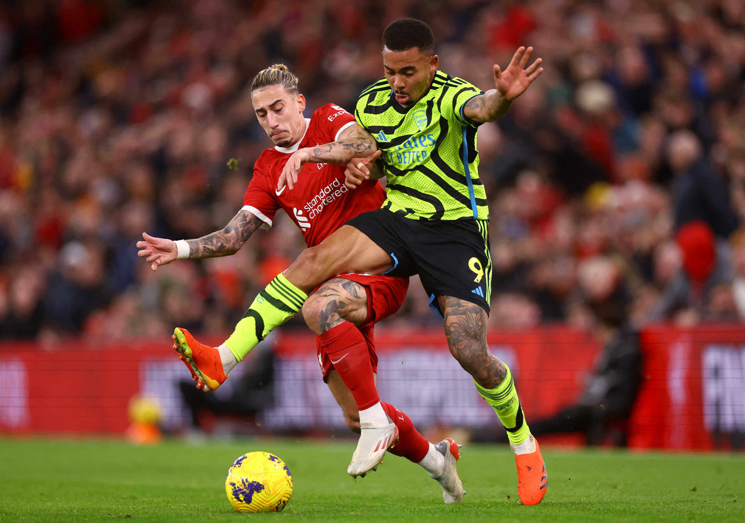 Soccer Football - Premier League - Liverpool v Arsenal - Anfield, Liverpool, Britain - December 23, 2023  Arsenal's Gabriel Jesus in action with Liverpool's Kostas Tsimikas REUTERS