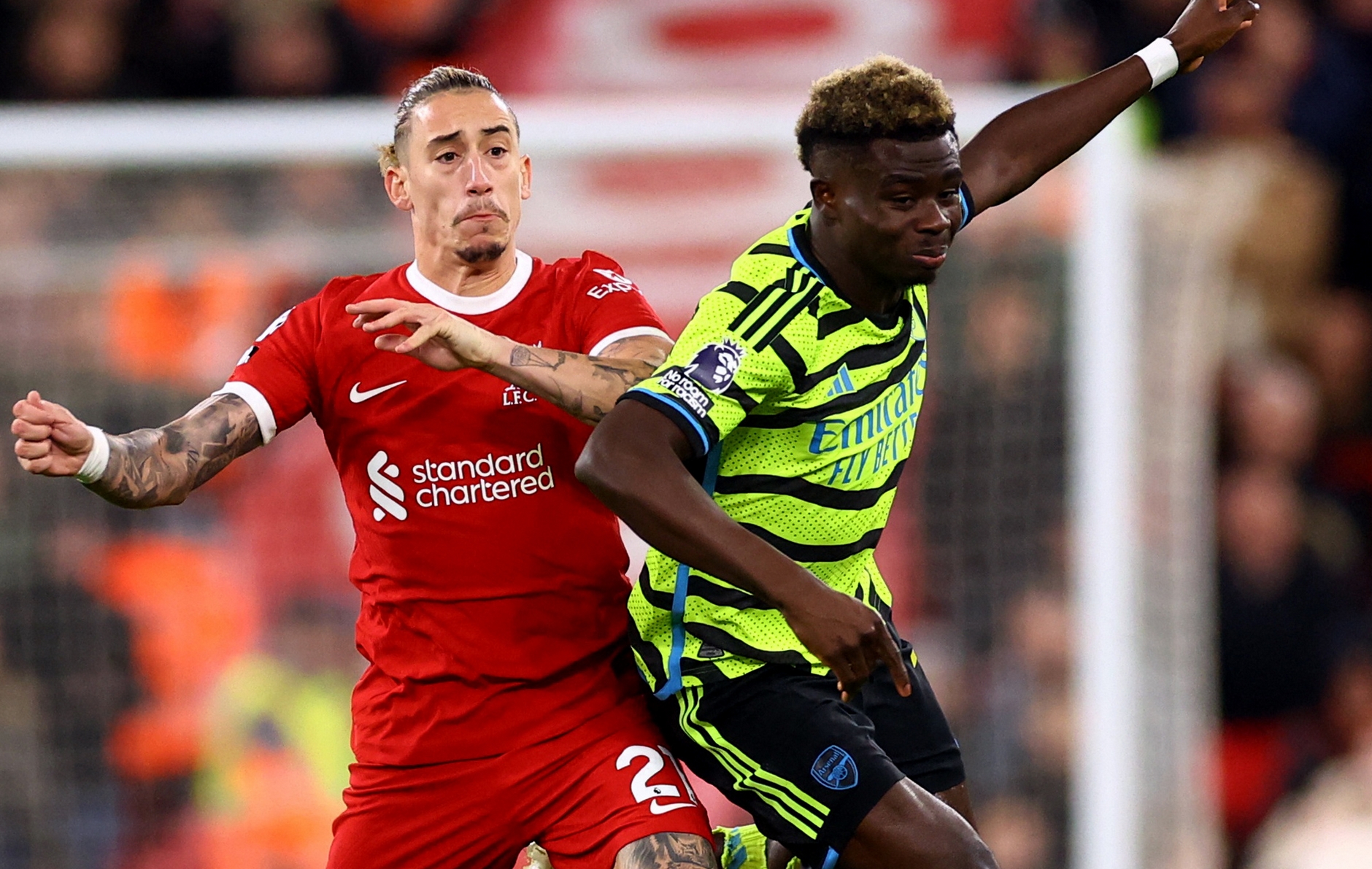 Soccer Football - Premier League - Liverpool v Arsenal - Anfield, Liverpool, Britain - December 23, 2023  Arsenal's Bukayo Saka in action with Liverpool's Kostas Tsimikas REUTERS