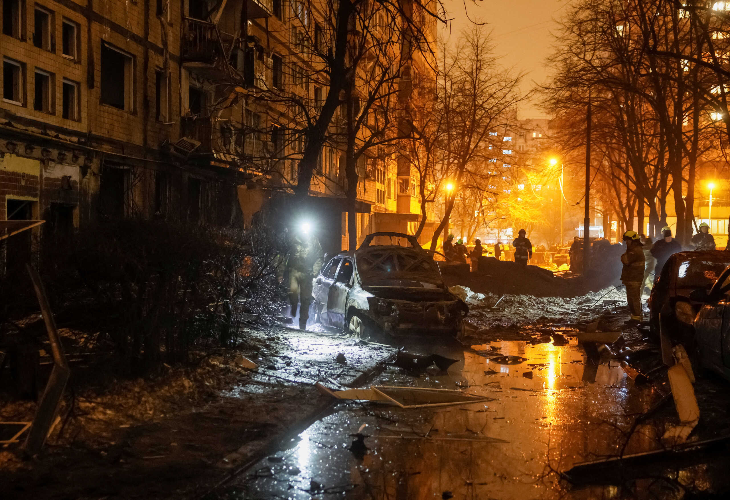 Emergency staff work at a site of an apartment building damaged during a Russian missile strike, amid Russia's attack on Ukraine, in Kyiv, Ukraine December 13, 2023. REUTERS