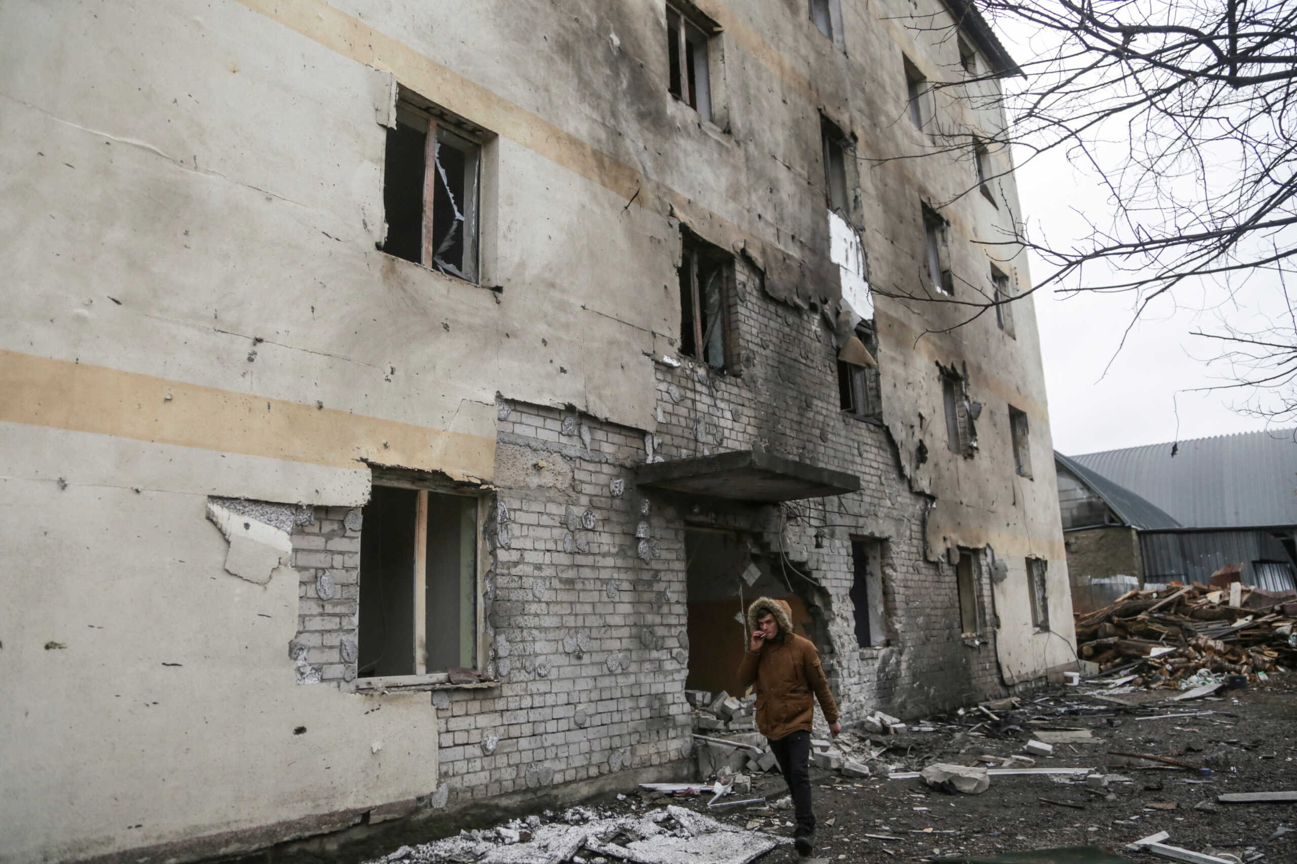 A man walks next to a residential building damaged by a Russian drone strike, amid Russia's attack on Ukraine, in Odesa, Ukraine December 14, 2023. REUTERS