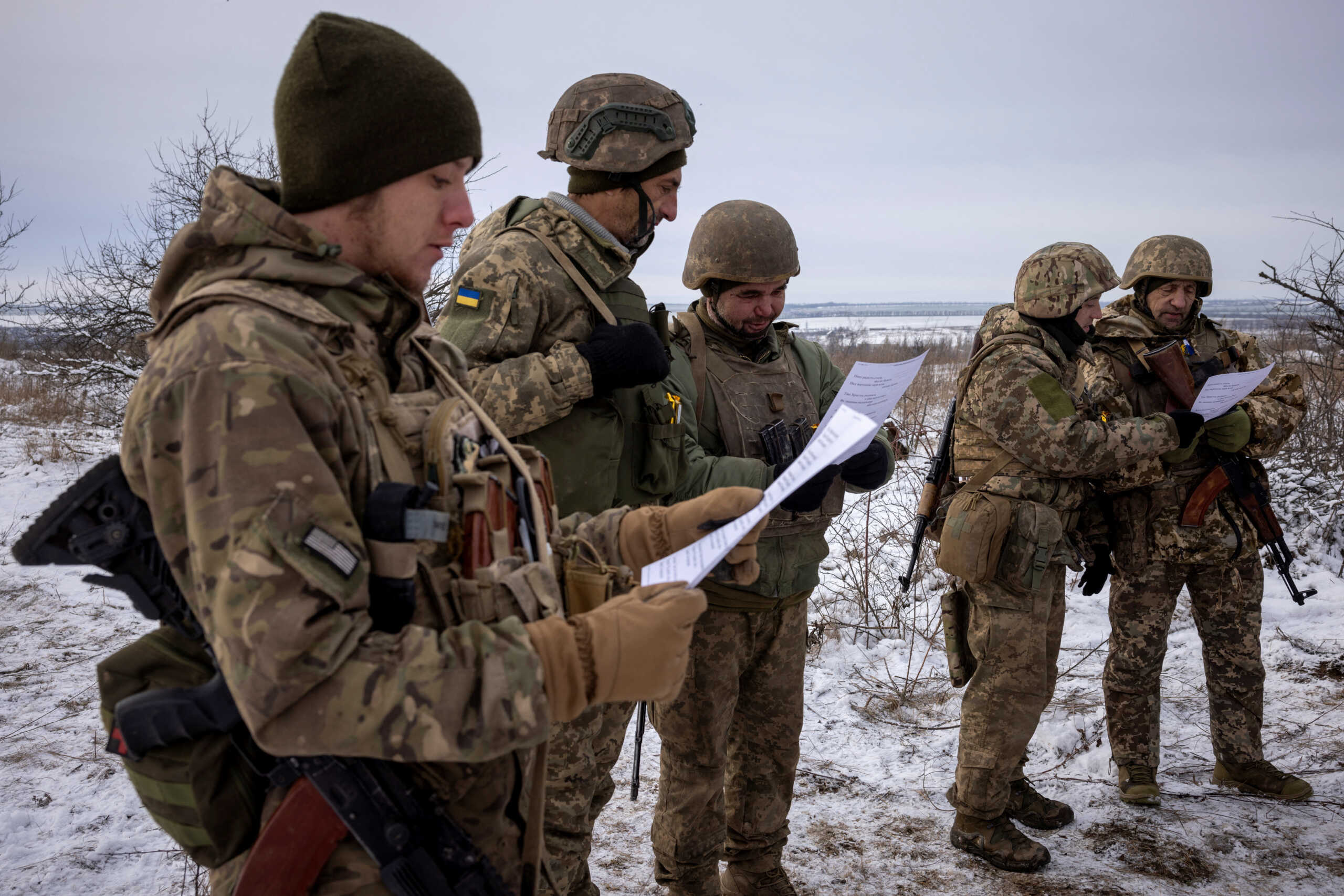 Ukrainian servicemen of the 93rd separate mechanized brigade sing during a Christmas Day service near the front line in the Donetsk region as Ukrainians celebrate their first Christmas according to a new calendar, amid Russia’s attack on Ukraine, December 25, 2023.  REUTERS