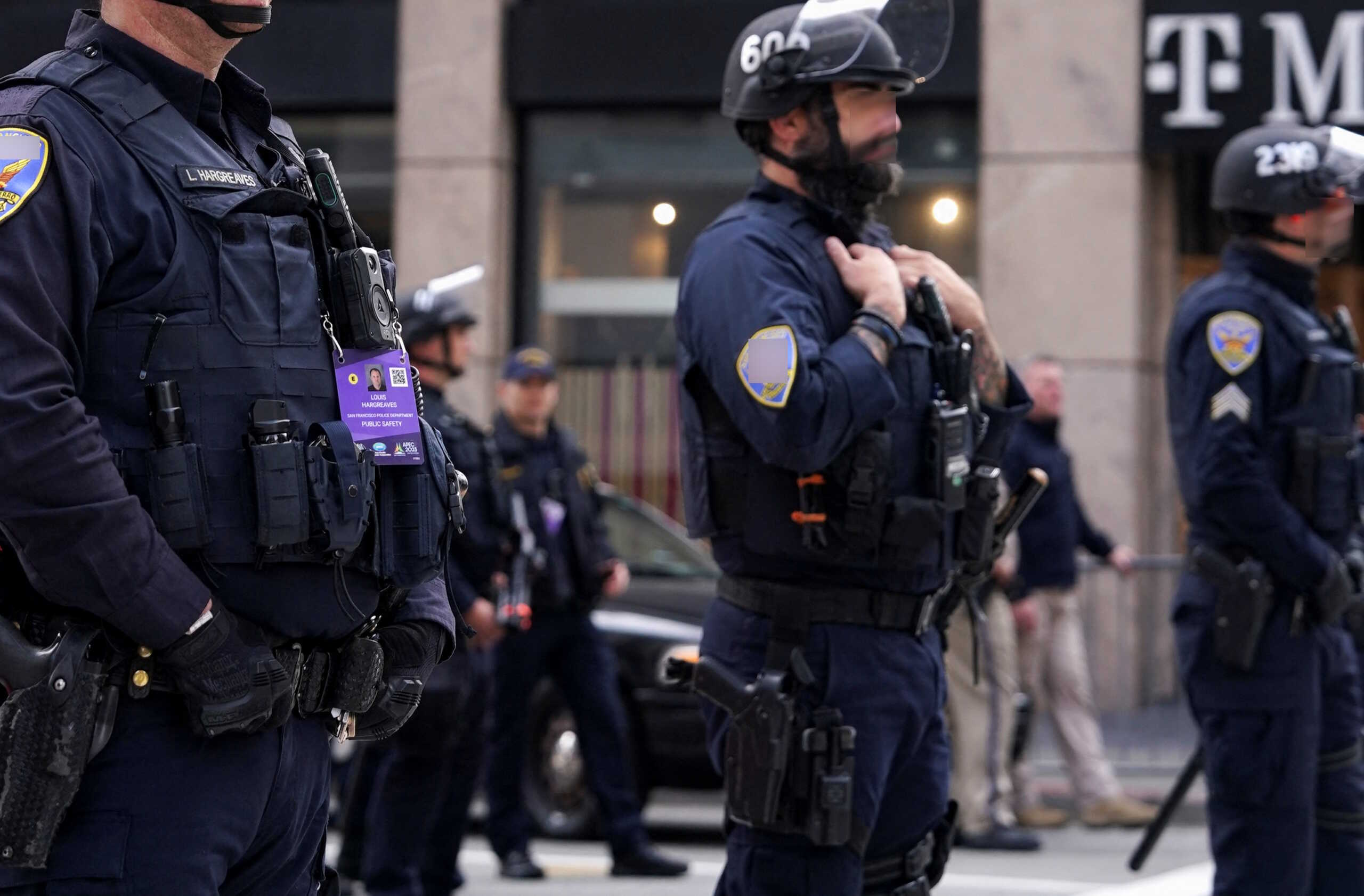 Police officers stand guard, as people protest against Chinese President Xi Jinping on the day of Asia-Pacific Economic Cooperation (APEC) CEO Summit in San Francisco, California, U.S. November 15, 2023. REUTERS