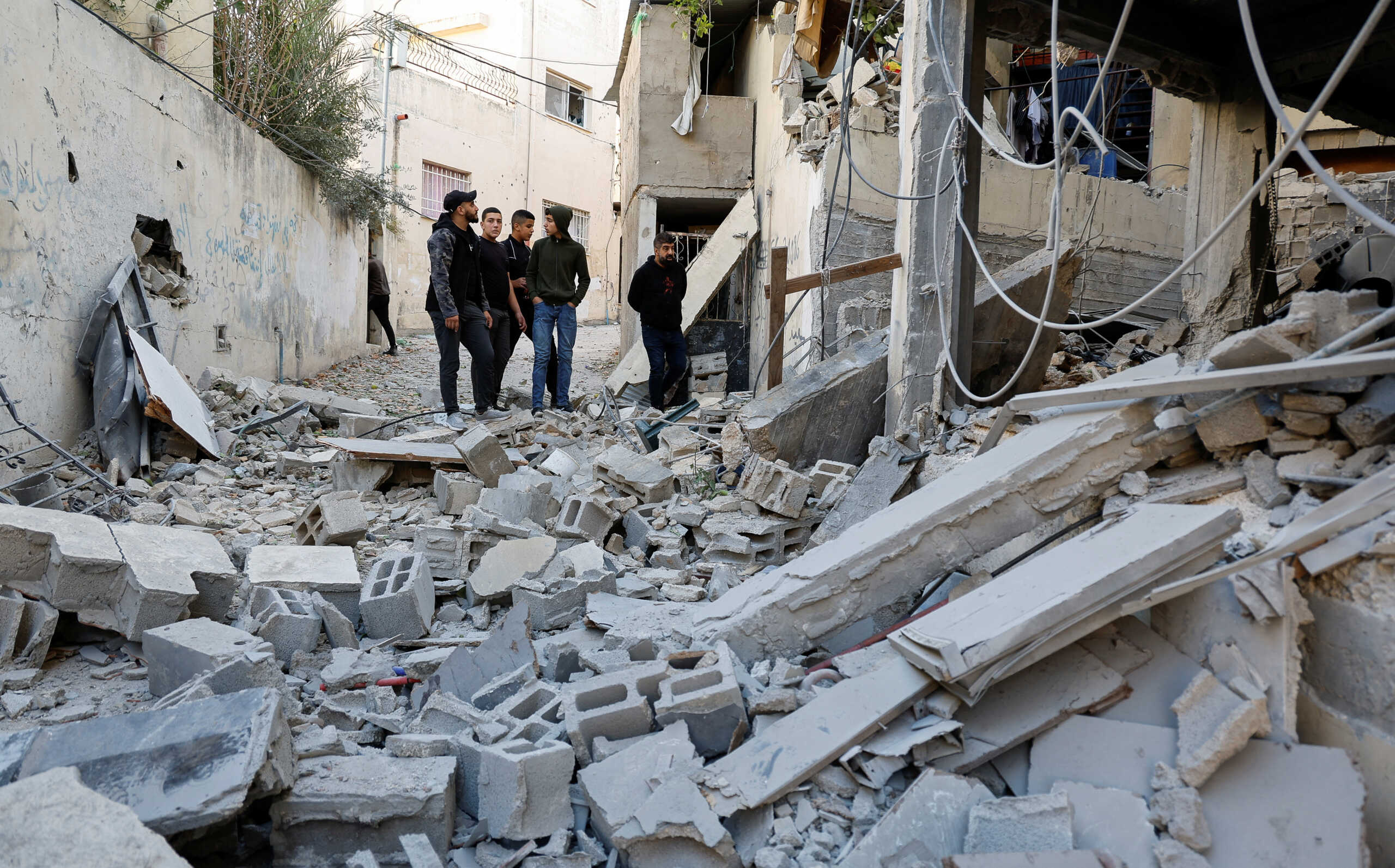Palestinians check damage following a raid in Jenin in the Israeli-occupied West Bank, November 29, 2023. REUTERS