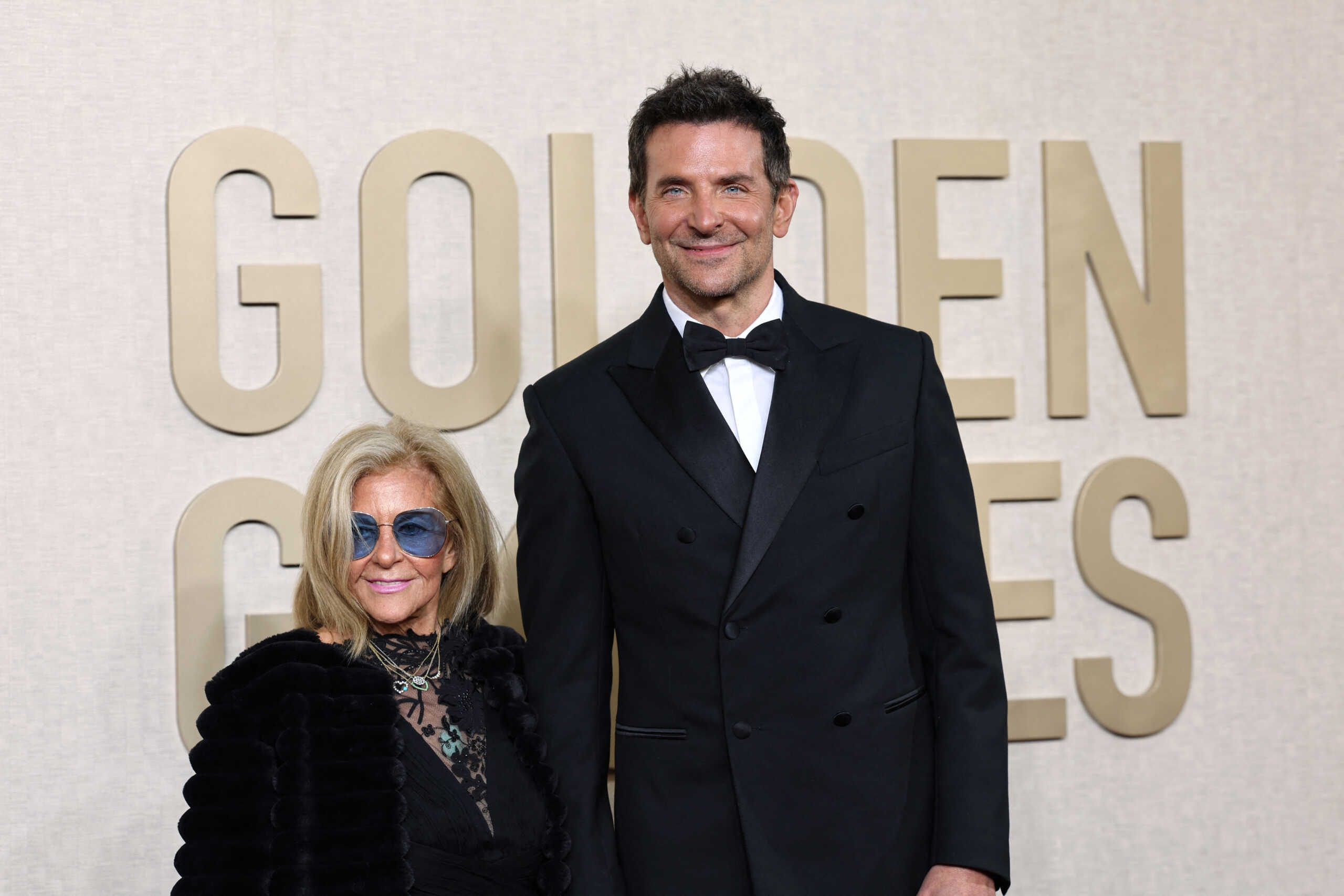 Gloria Campano and Bradley Cooper attend the 81st Annual Golden Globe Awards in Beverly Hills, California, U.S., January 7, 2024. REUTERS