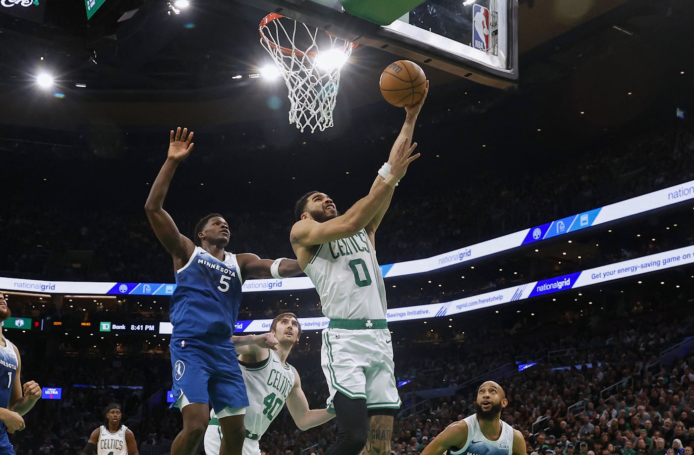 Jan 10, 2024; Boston, Massachusetts, USA; Boston Celtics forward Jayson Tatum (0) goes to the basket past Minnesota Timberwolves guard Anthony Edwards (5) during the second half at TD Garden. Mandatory Credit: Winslow Townson-USA TODAY Sports