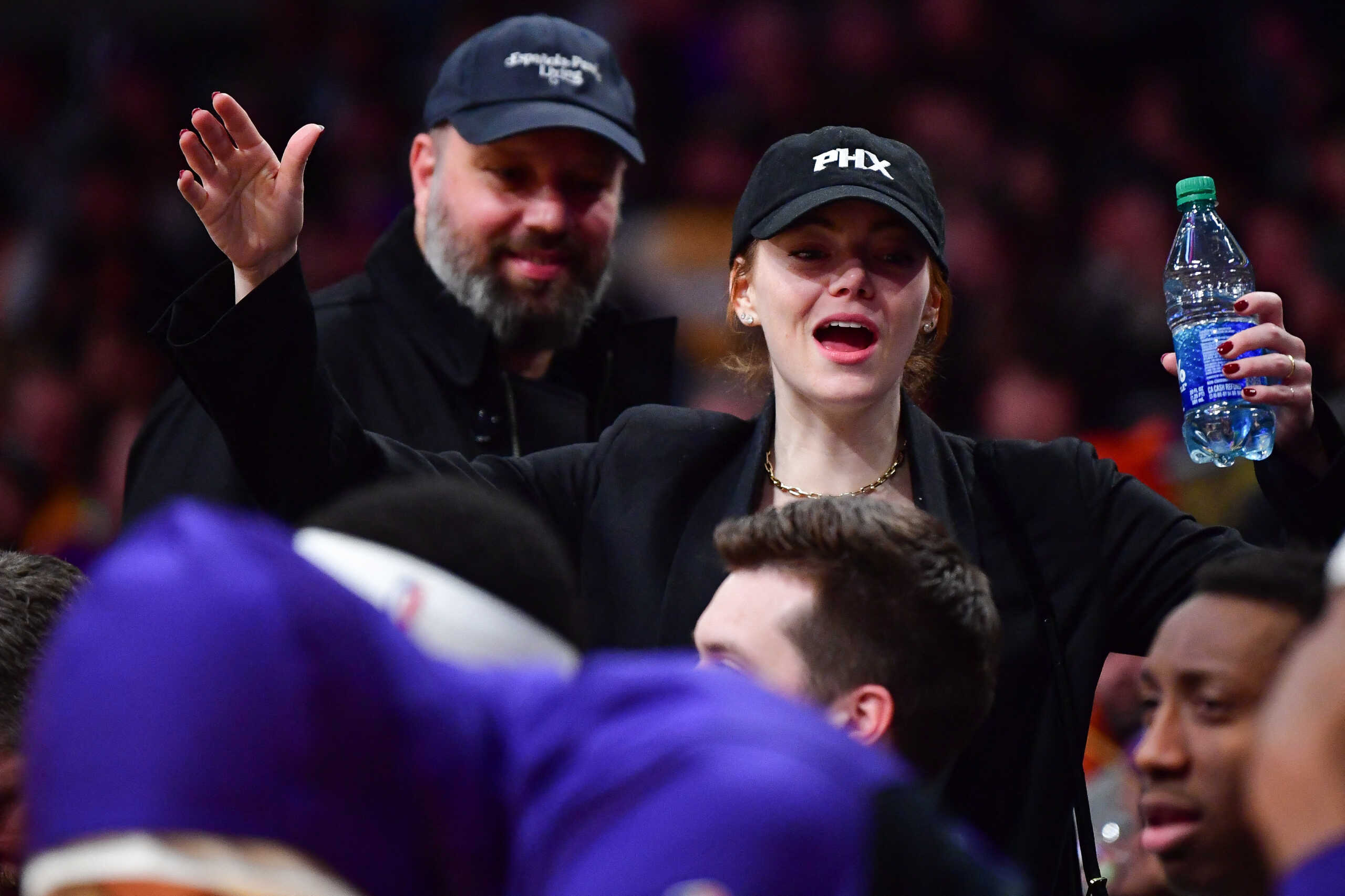 Jan 11, 2024; Los Angeles, California, USA; Film actress Emma Stone greets the Phoenix Suns bench during the second half at Crypto.com Arena. Mandatory Credit: Gary A. Vasquez-USA TODAY Sports