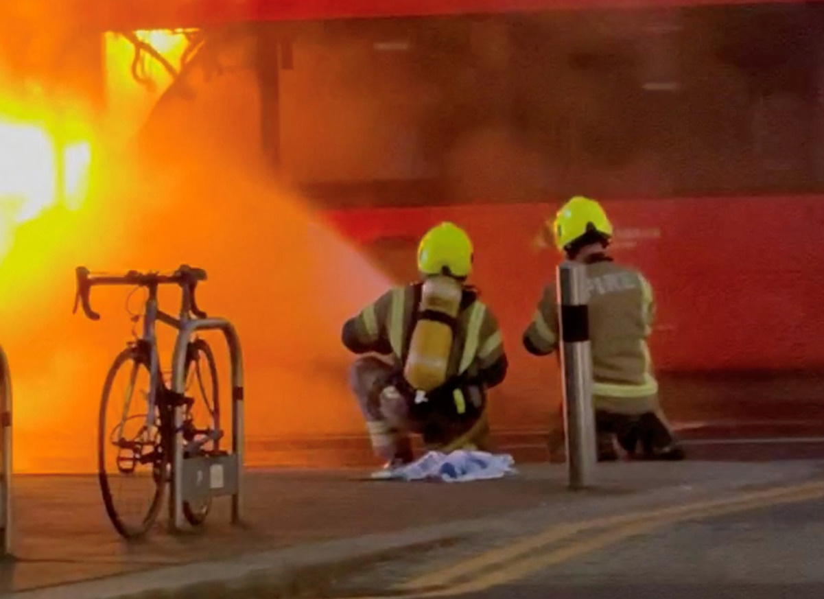Firefighters extinguish a fire in a double decker bus in London, Britain, January 11, 2024, in this screen grab obtained from social media video. Instagram