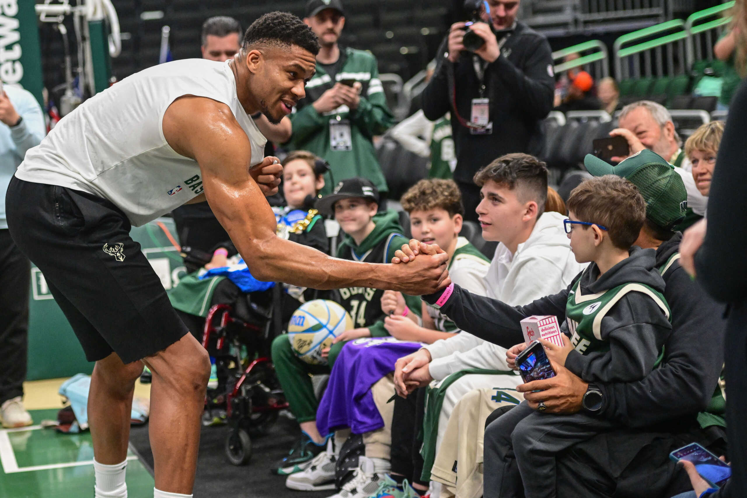 Dec 16, 2023; Milwaukee, Wisconsin, USA; Milwaukee Bucks forward Giannis Antetokounmpo (34) greets Make-A-Wish Wisconsin children before game against the Detroit Pistons at Fiserv Forum. Mandatory Credit: Benny Sieu-USA TODAY Sports