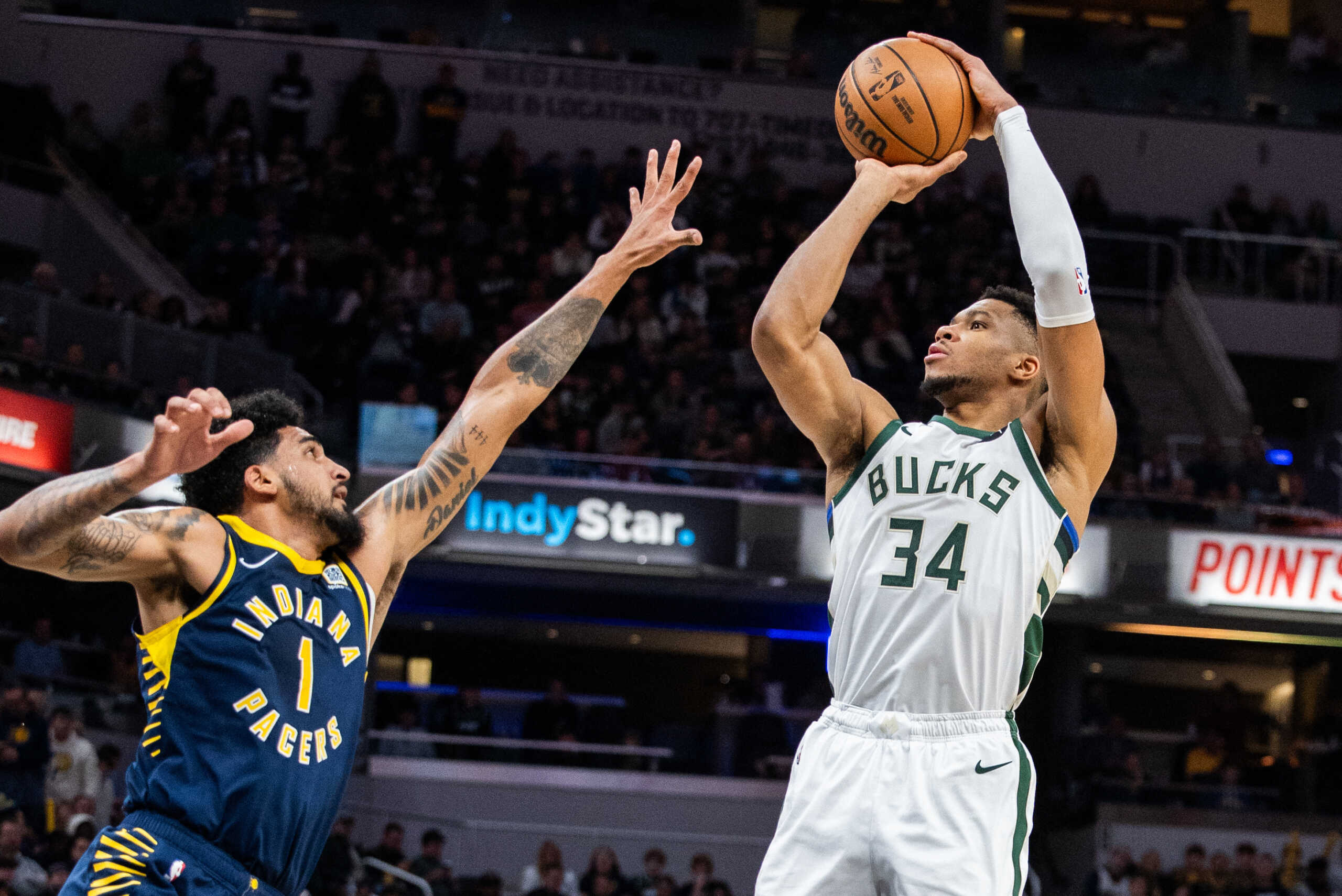 Jan 3, 2024; Indianapolis, Indiana, USA; Milwaukee Bucks forward Giannis Antetokounmpo (34) shoots the ball while Indiana Pacers forward Obi Toppin (1) defends in the second quarter at Gainbridge Fieldhouse. Mandatory Credit: Trevor Ruszkowski-USA TODAY Sports