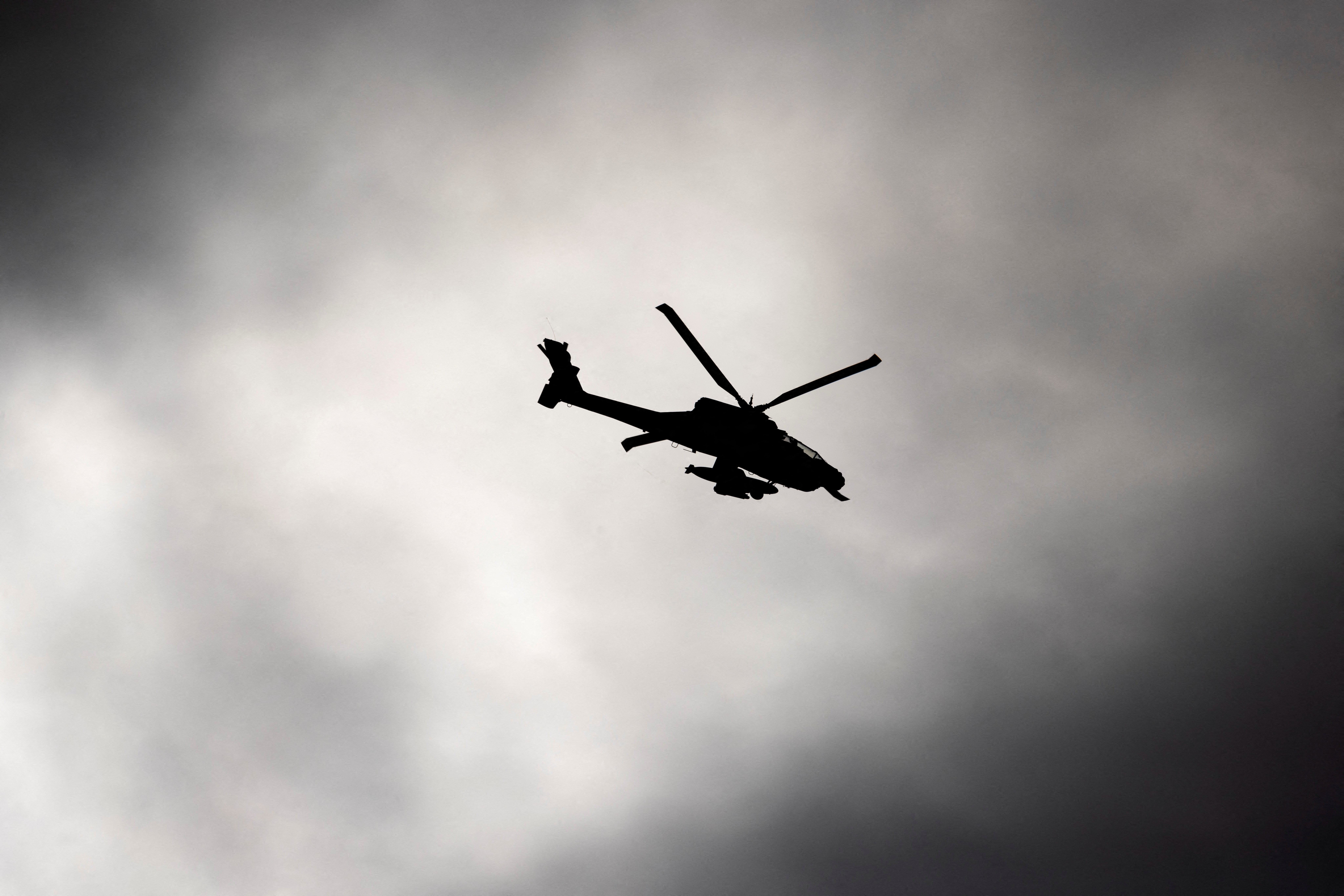 An Israeli military Apache helicopter flies over Ashkelon, Israel, amid the ongoing conflict between Israel and the Palestinian Islamist group Hamas, December 24, 2023. REUTERS