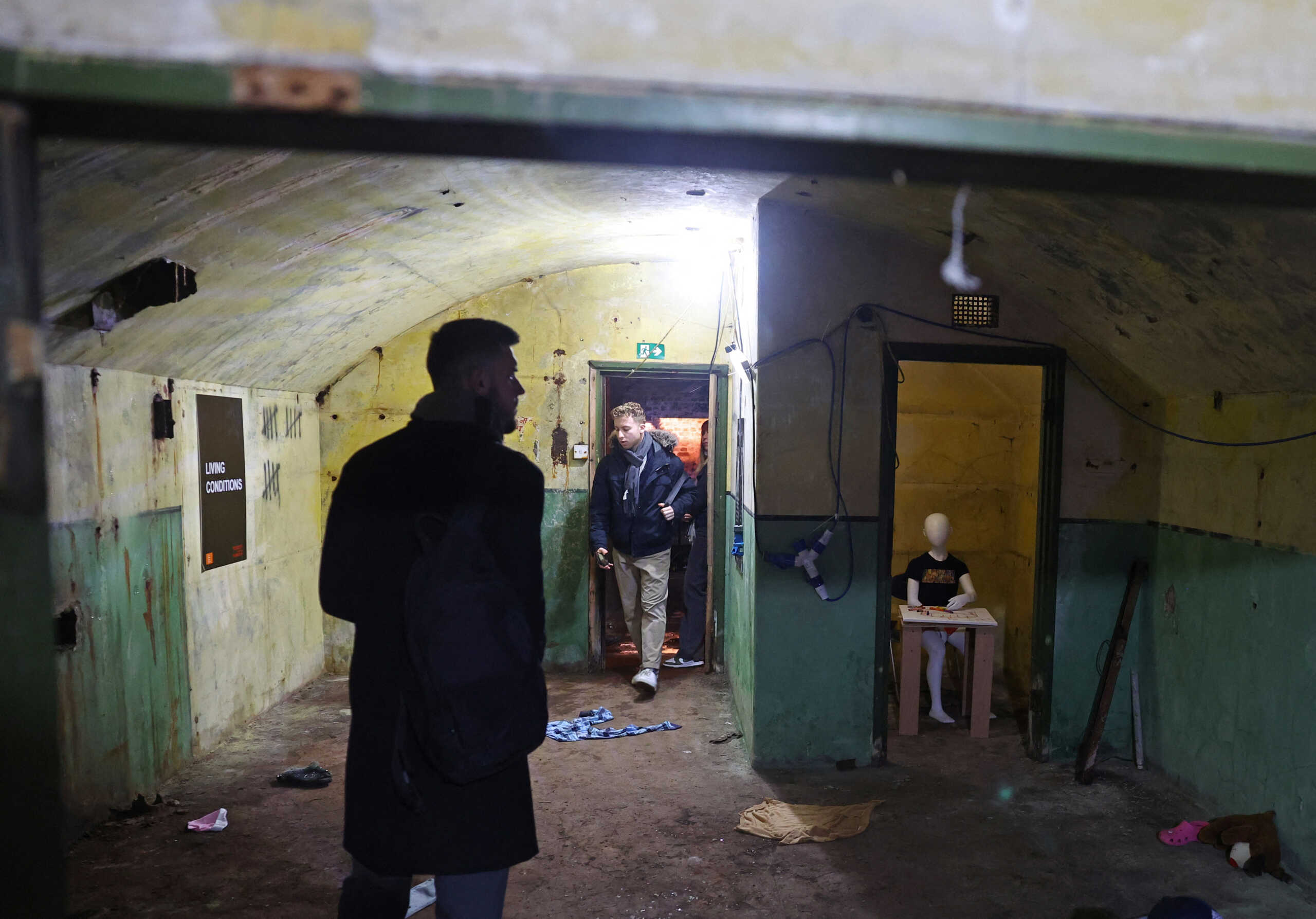 Visitors view 'Voices From The Tunnels', an exhibition organised by 7